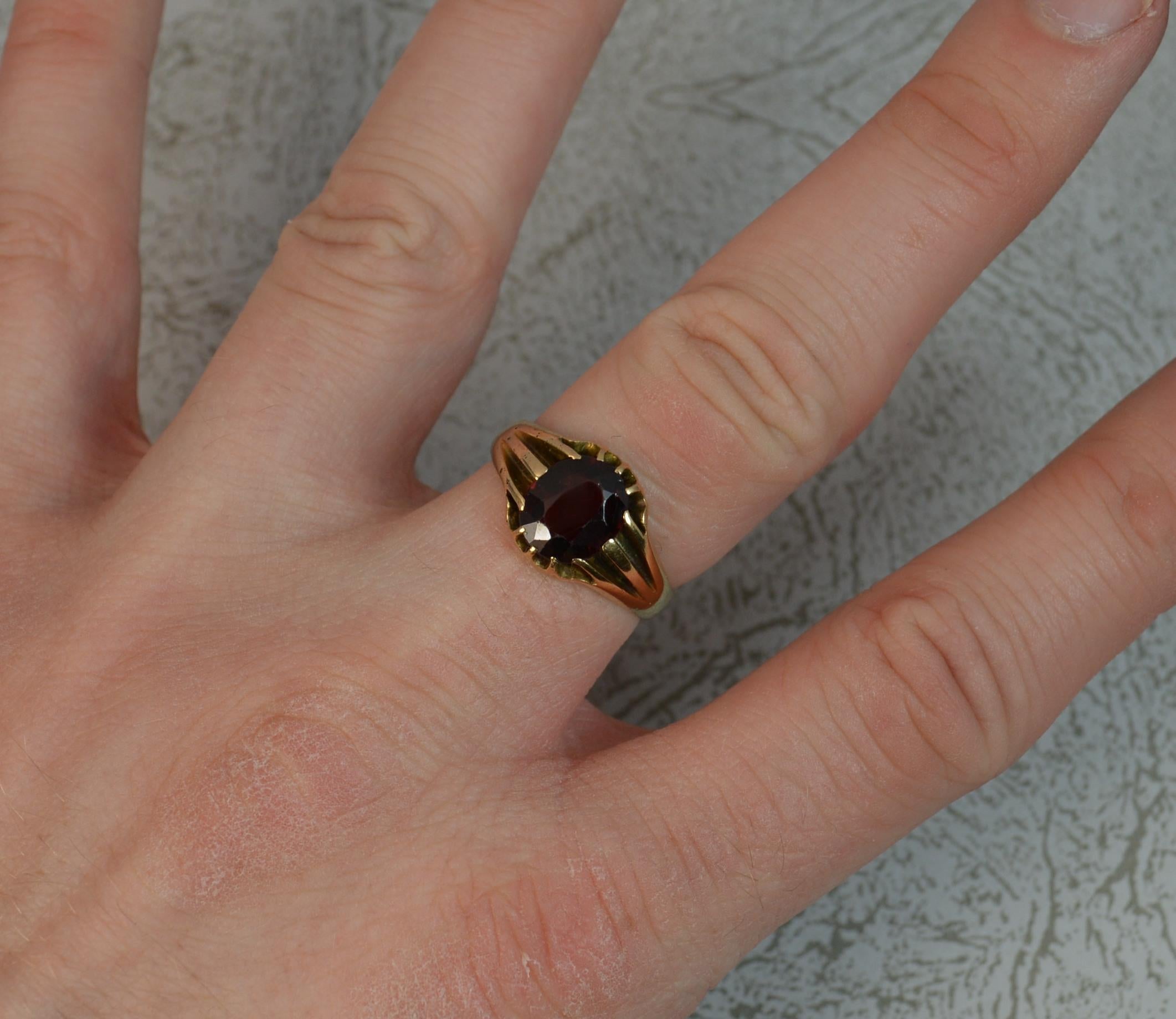 A superb late Victorian unisex gypsy solitaire ring.
Solid 18 carat yellow gold shank.
Set with a single oval cut garnet in claw setting. 7.6mm x 9mm.
CONDITION ; Very good. Well set garnet, light surface wear. Small pitting marks to shoulders. 
