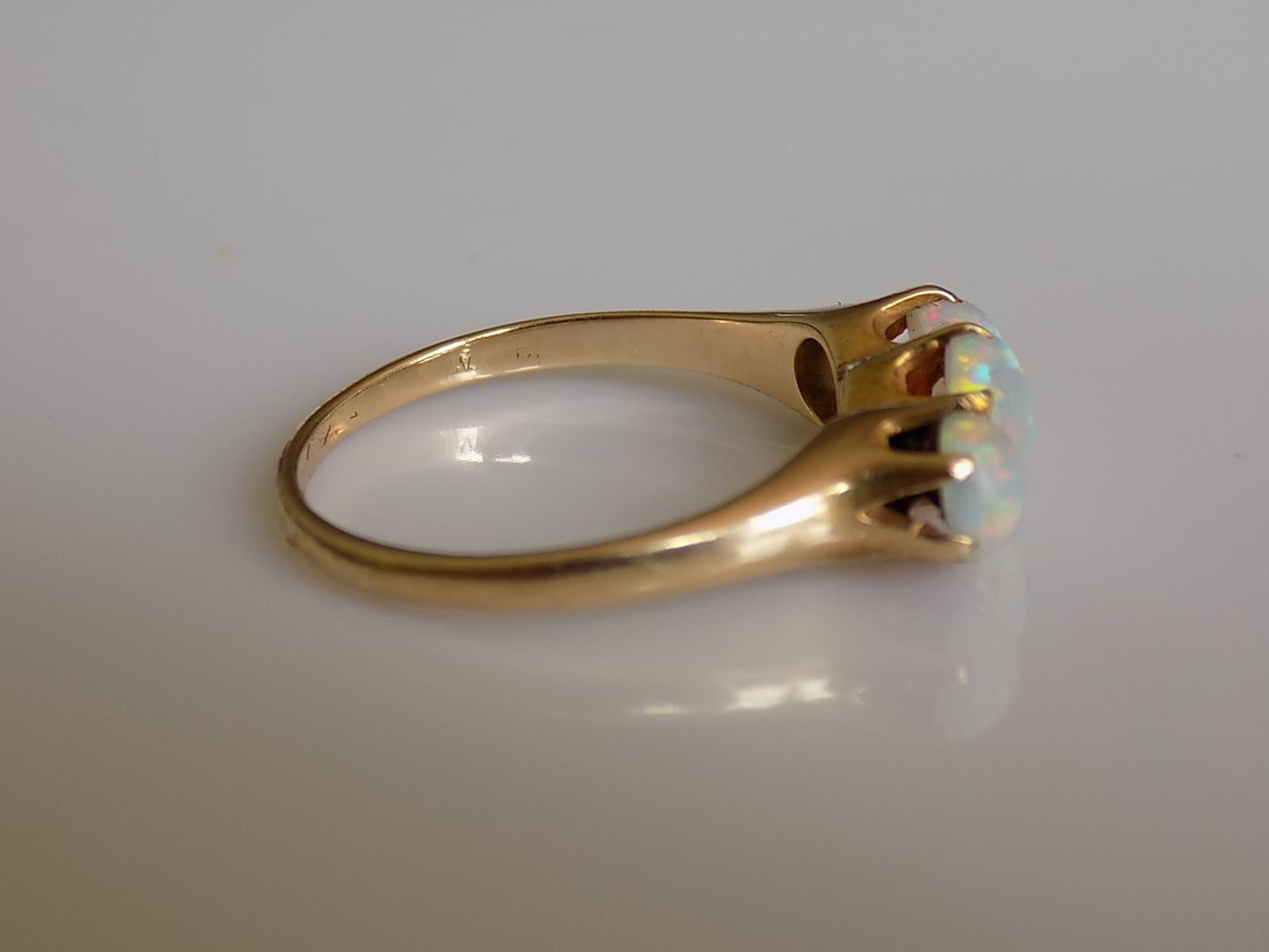A Lovely Victorian 18 Carat Gold and three Australian Opal ring.
Size M UK, 6.5 US (can be sized).
Height of the face including claws 6mm.
Weight 2.4gr.
Unmarked, tested 18 Carat Gold.
The ring in very good condition and ready to wear.