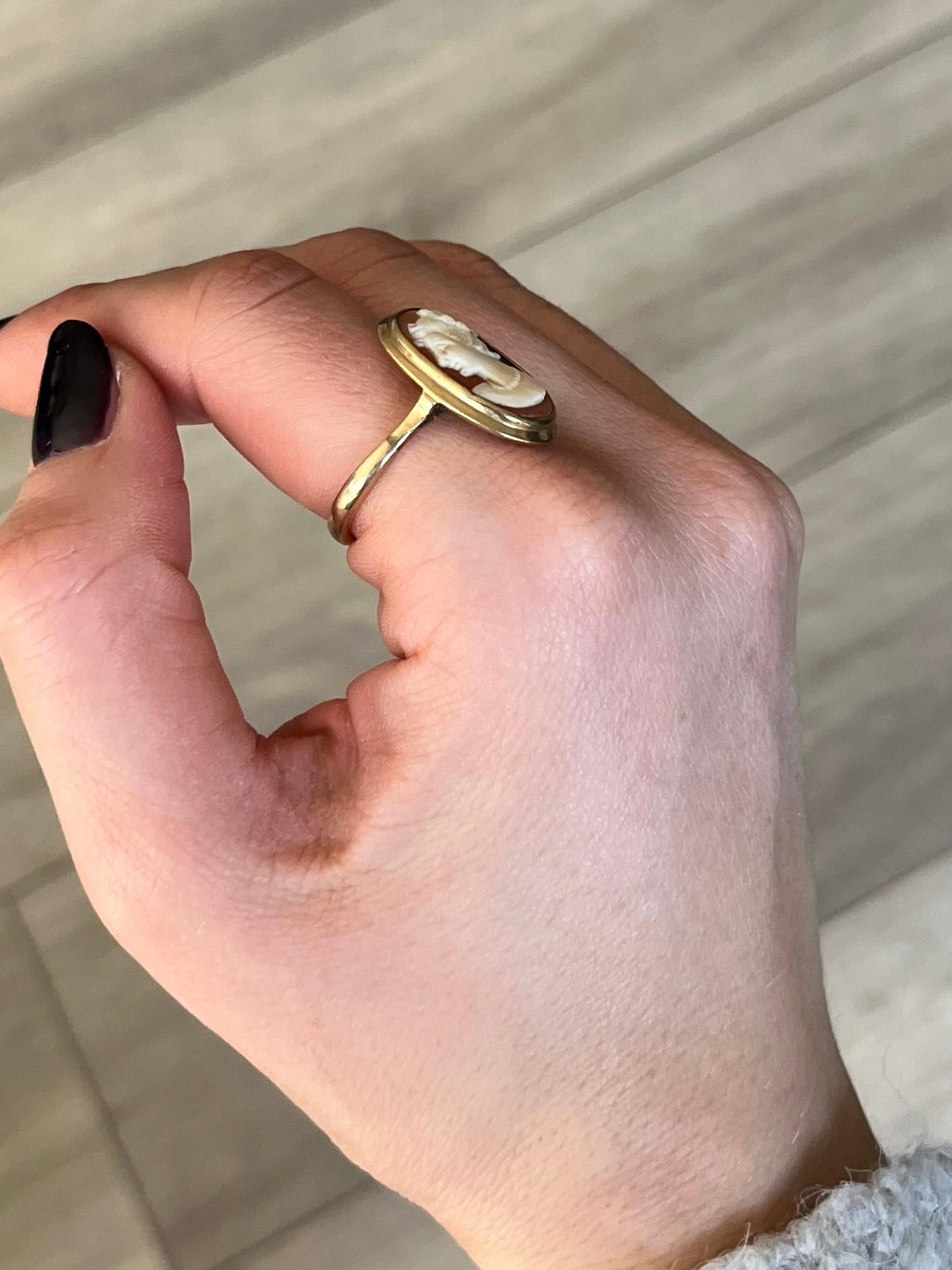 The carved woman is set in a simple frame and this is perched upon an 18carat gold shank. Hallmarked London 1946.

Ring Size: Q or 8 
Panel Dimensions: 21x14mm

Weight: 4.3g