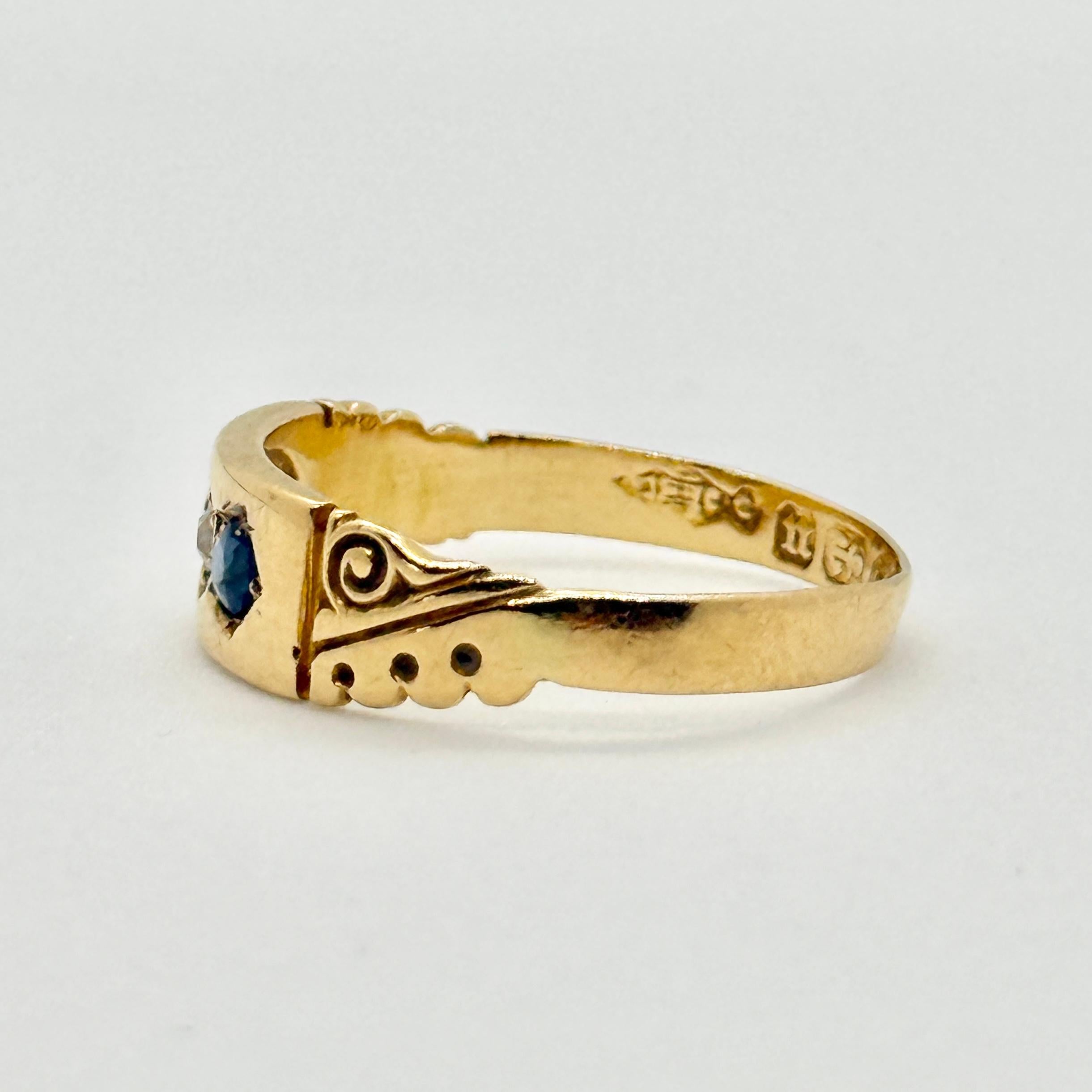 This ring holds a diamond at the centre measuring approx 7pts and two sapphires measuring 10pts each. Fully hallmarked Birmingham 1894. 

Ring Size: M 1/2 or 6 1/2
Band Width: 6mm

Weight: 2.1g