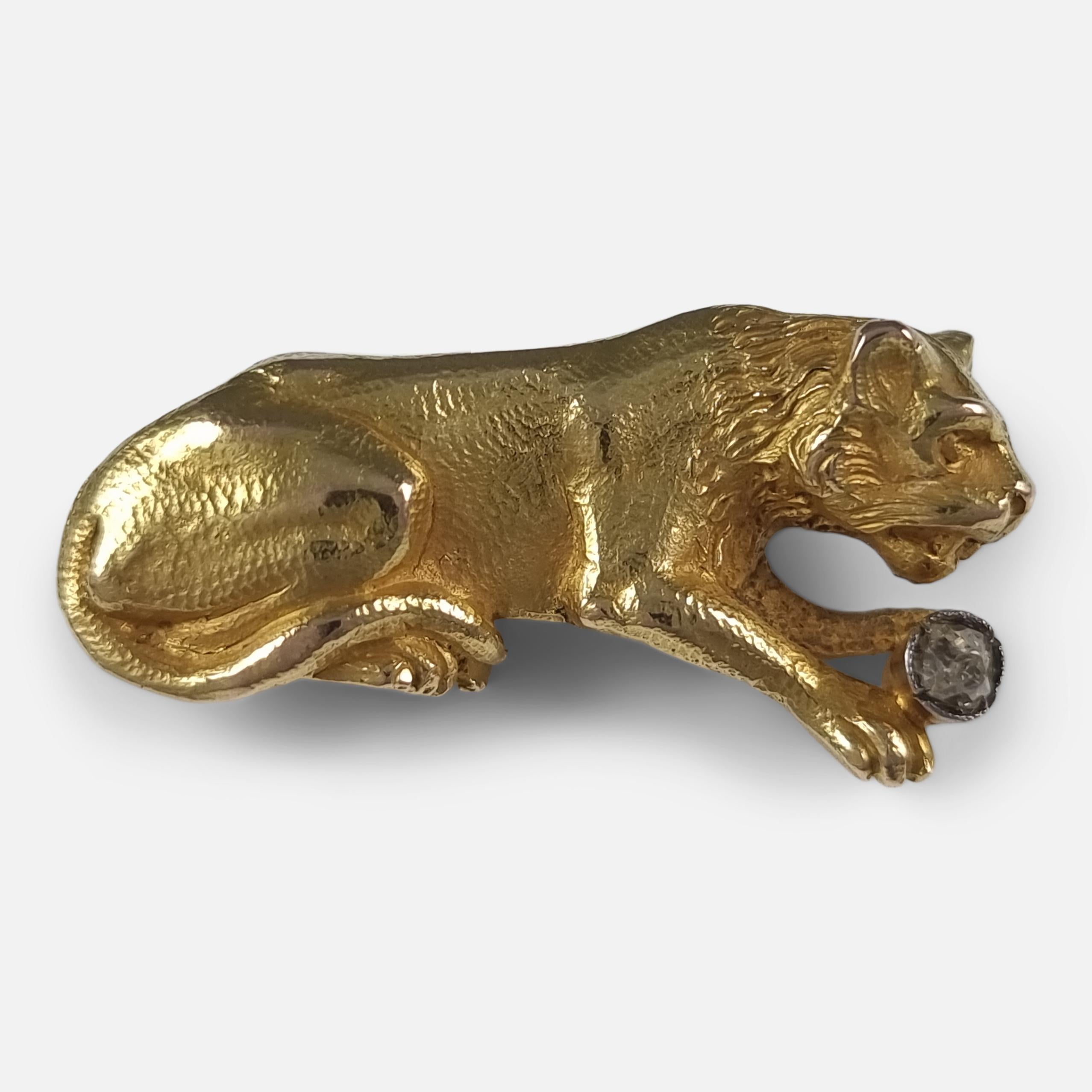 This late Victorian brooch, dating back to circa 1900, showcases an 18ct gold lioness holding a 0.08 ct old cut diamond. True to the period's craftsmanship, it lacks hallmarks but is verified as 18 carat gold.

 • Measurements: 3.3cm (L) x 1.7cm (H)