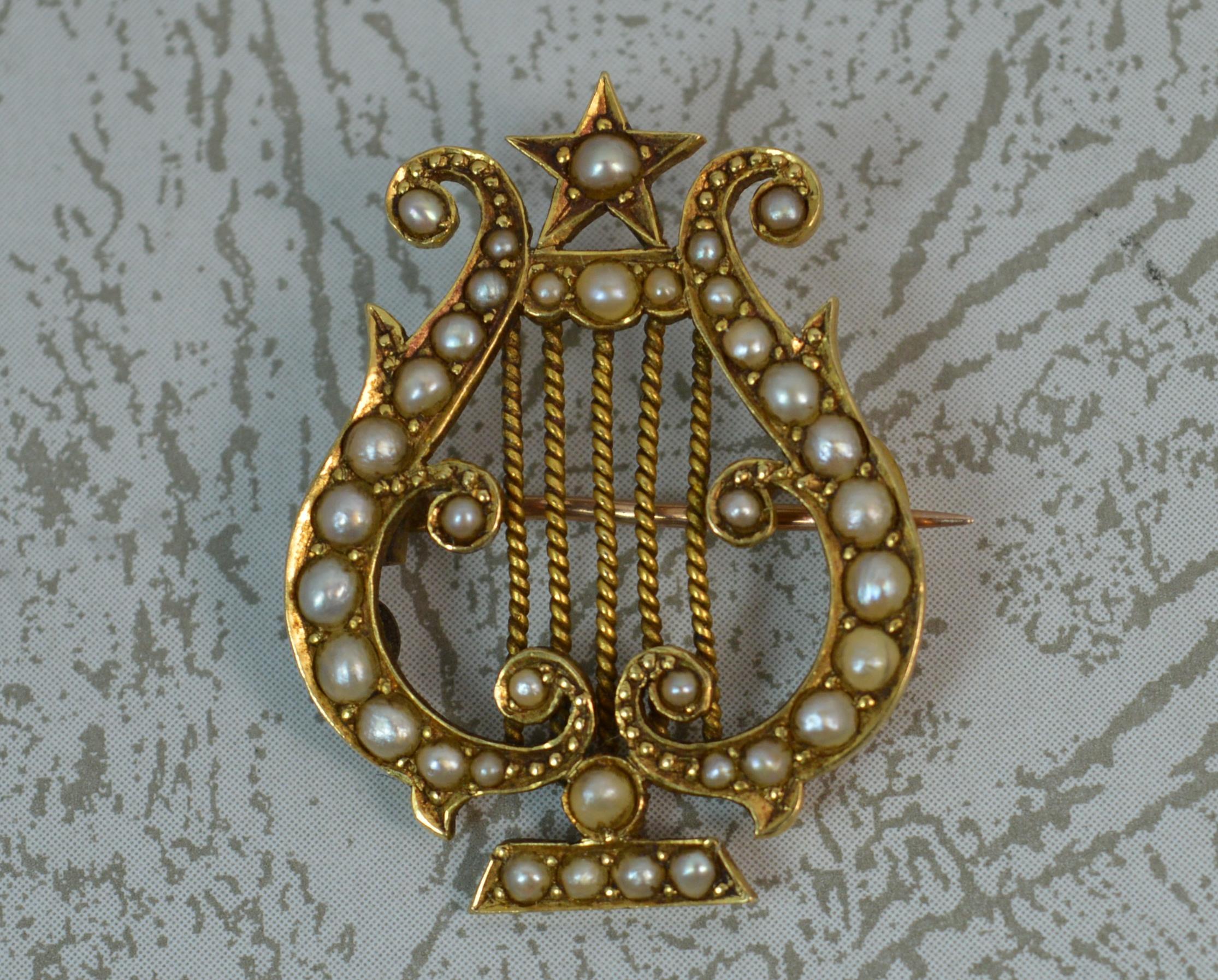 A fine 18 carat gold and seed pearl brooch. Modelled as a Lyre. 
True Victorian era, c1880. 
Well made example, attractive size.

CONDITION ; Excellent for age. Clean example. Securely set stones. Light wear only. Not perfectly straight in shape.