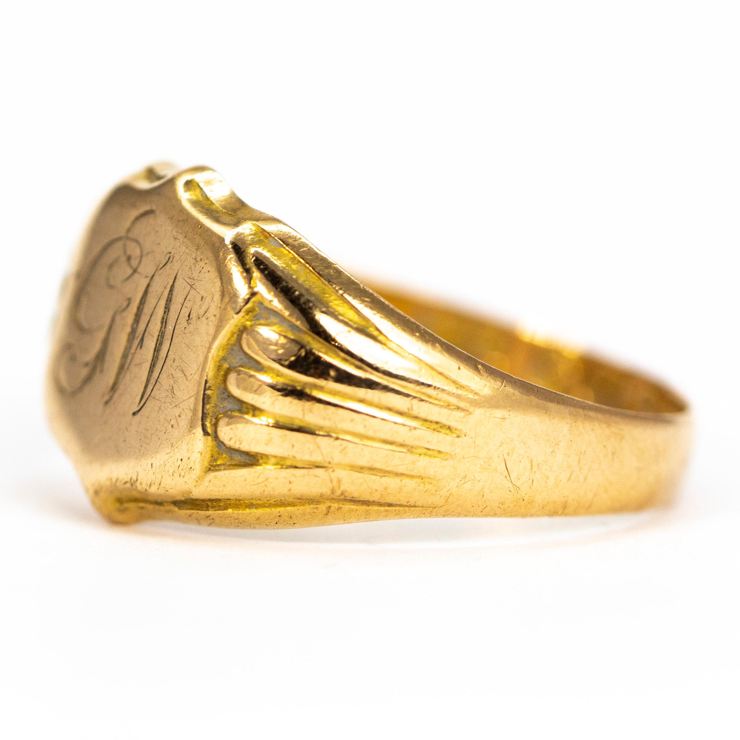 The fluid scroll font which reads 'GW' is finely engraved onto the main shield panel of this ring. The chunky shoulders have ribbed detail and carry on down into a plain band modelled in 18ct gold. Made in Birmingham, England.

RIng Size: R 1/2 or 8