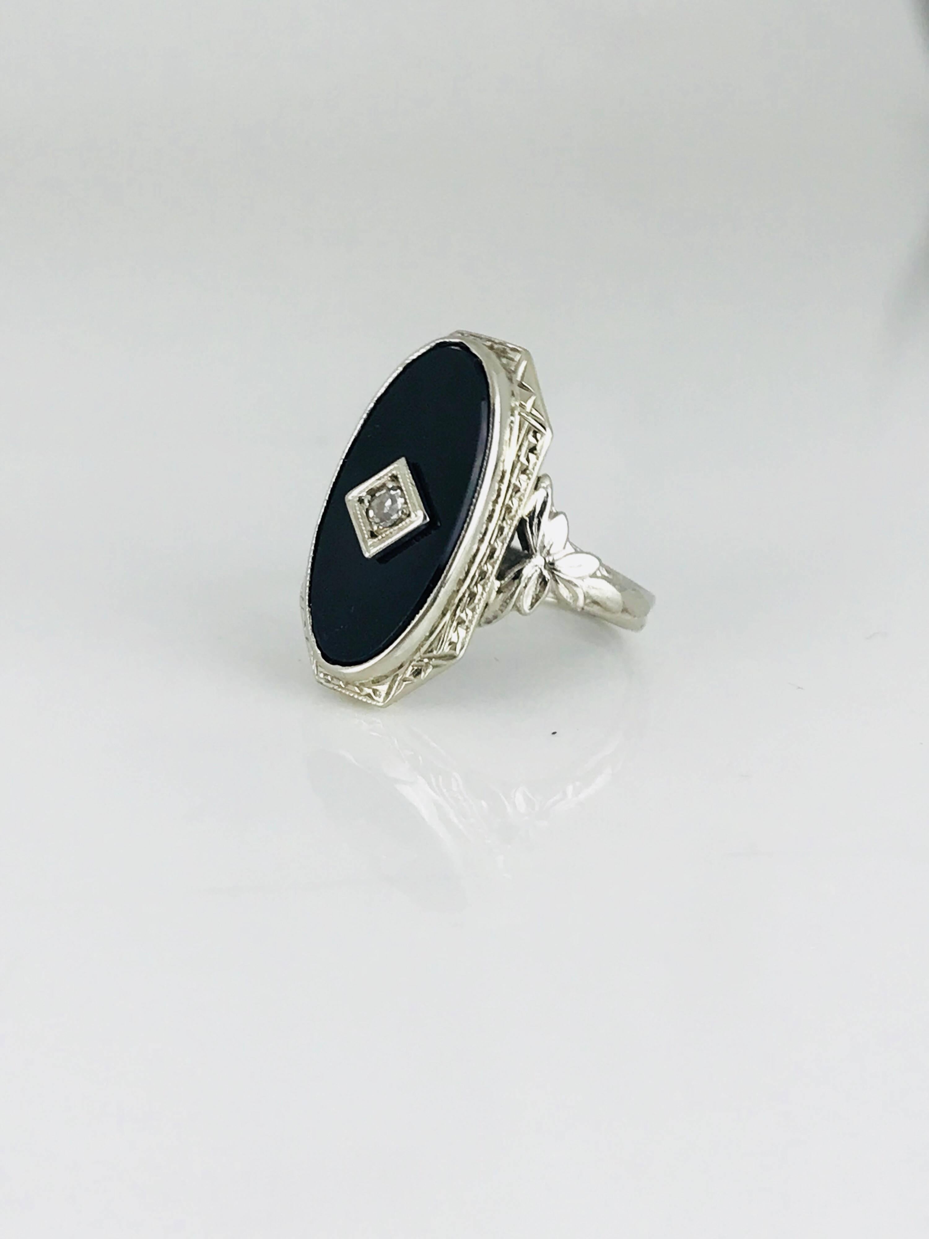 18 karat white gold, Victorian ring with a center round diamond. The diamond is a European-cut 2.50 millimeter stone weighing approximately .06 carat.

Size 2- 3/4
GIA Gemologist Inspected & Evaluated $1550.00