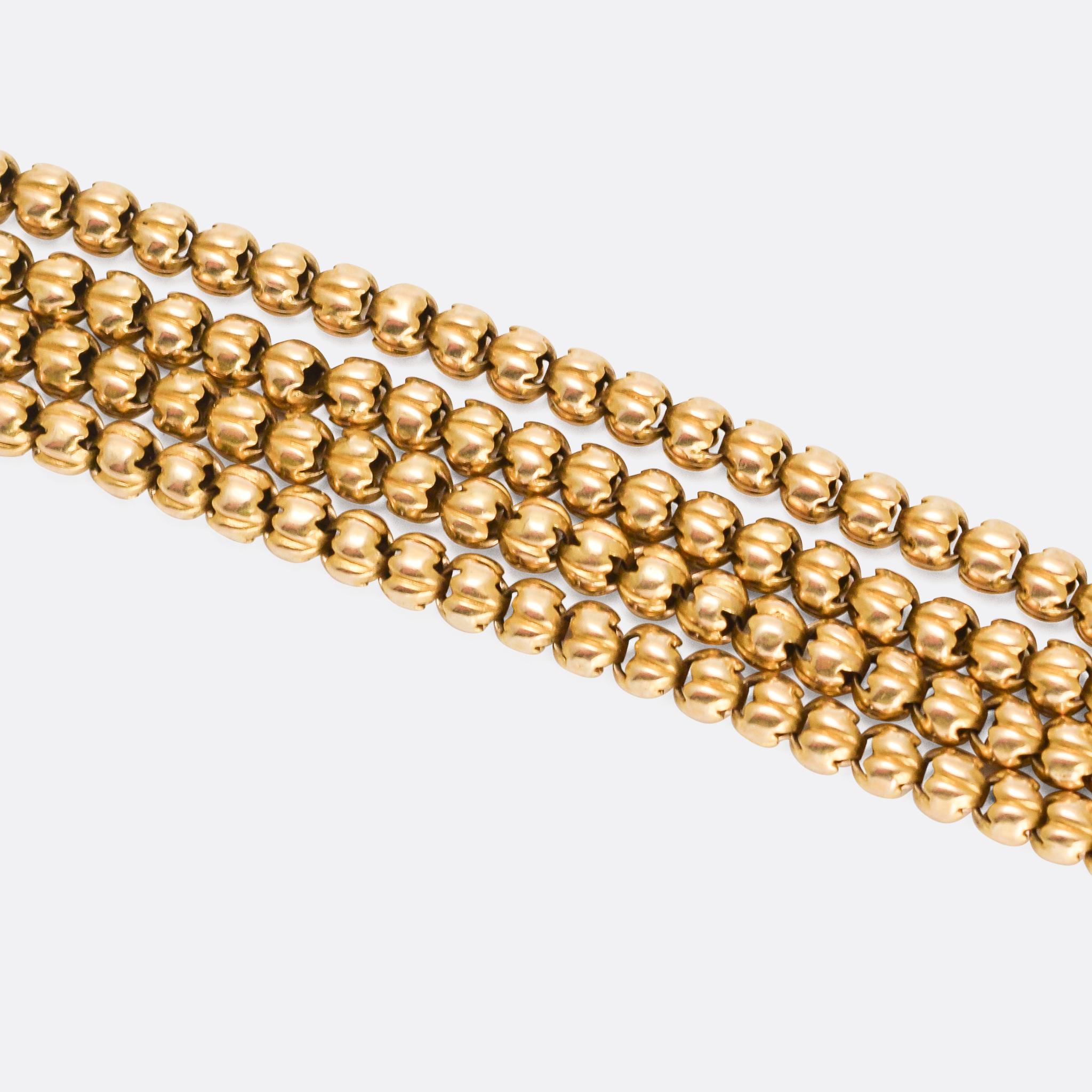A fine antique guard chain with fancy ball links and unusually modelled in 18 karat gold. It's long, at 72 inches, and very substantial at 45.4 grams. It dates from the latter half of the 19th Century, and remains complete with the original swivel