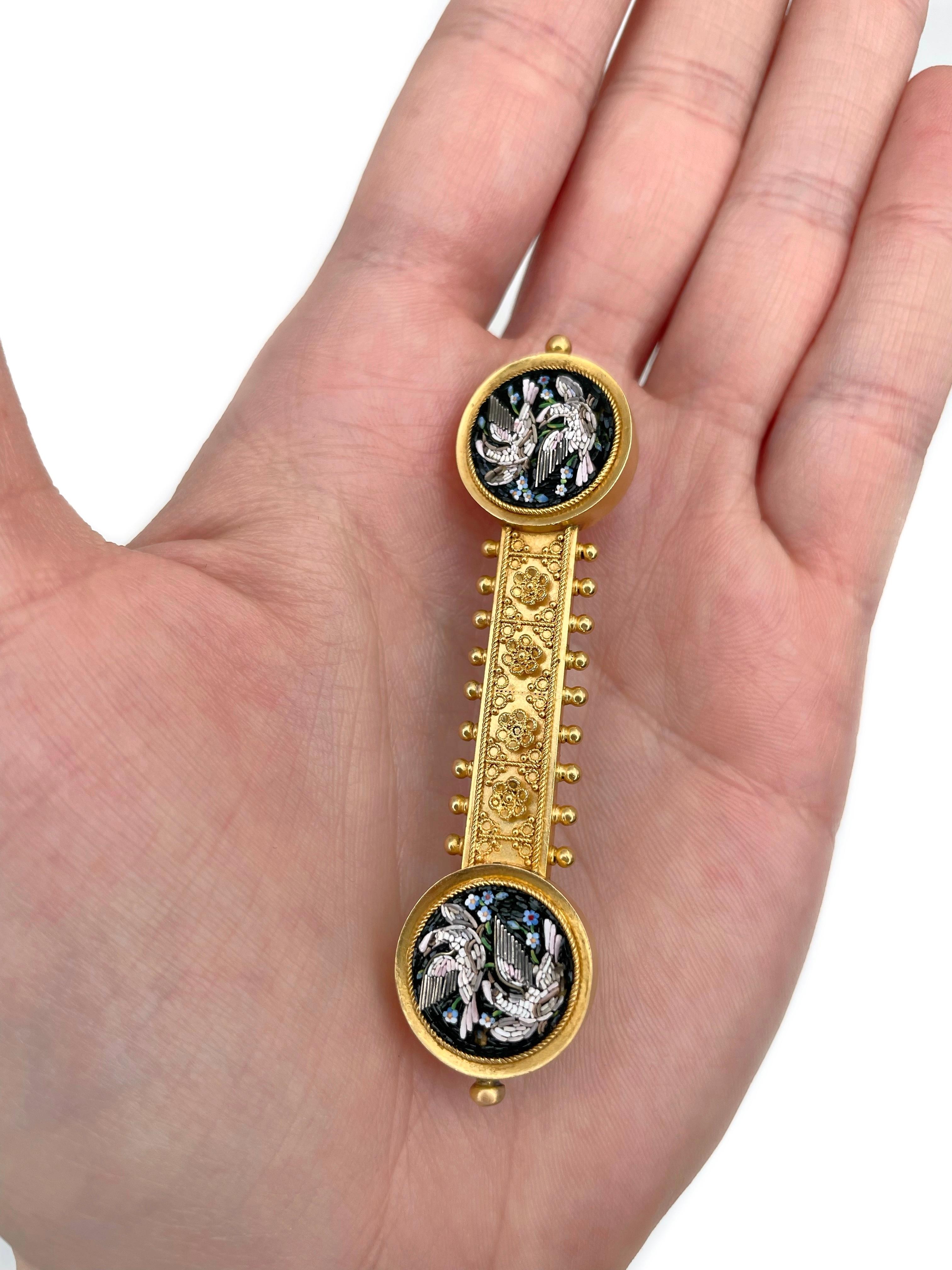 It is a lovely Victorian bar brooch crafted in 18K gold. The needle has been changed. Circa 1880. 

The piece features the detailed micro mosaics depicting birds (doves) and flowers (forget-me-nots). Few details are missing. 

Weight: 10.38g
Length: