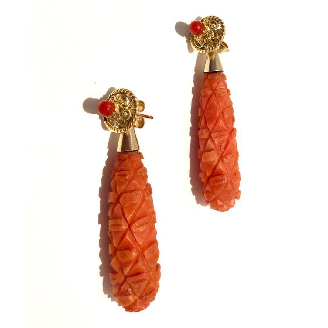 A lovely pair of 18 karat yellow gold Victorian carved coral torpedo drop earrings with carved diamond decoration with a tapered gold cap finial circa 1890. *Note* these earrings have been recently restored and the black inclusions (seen in the main