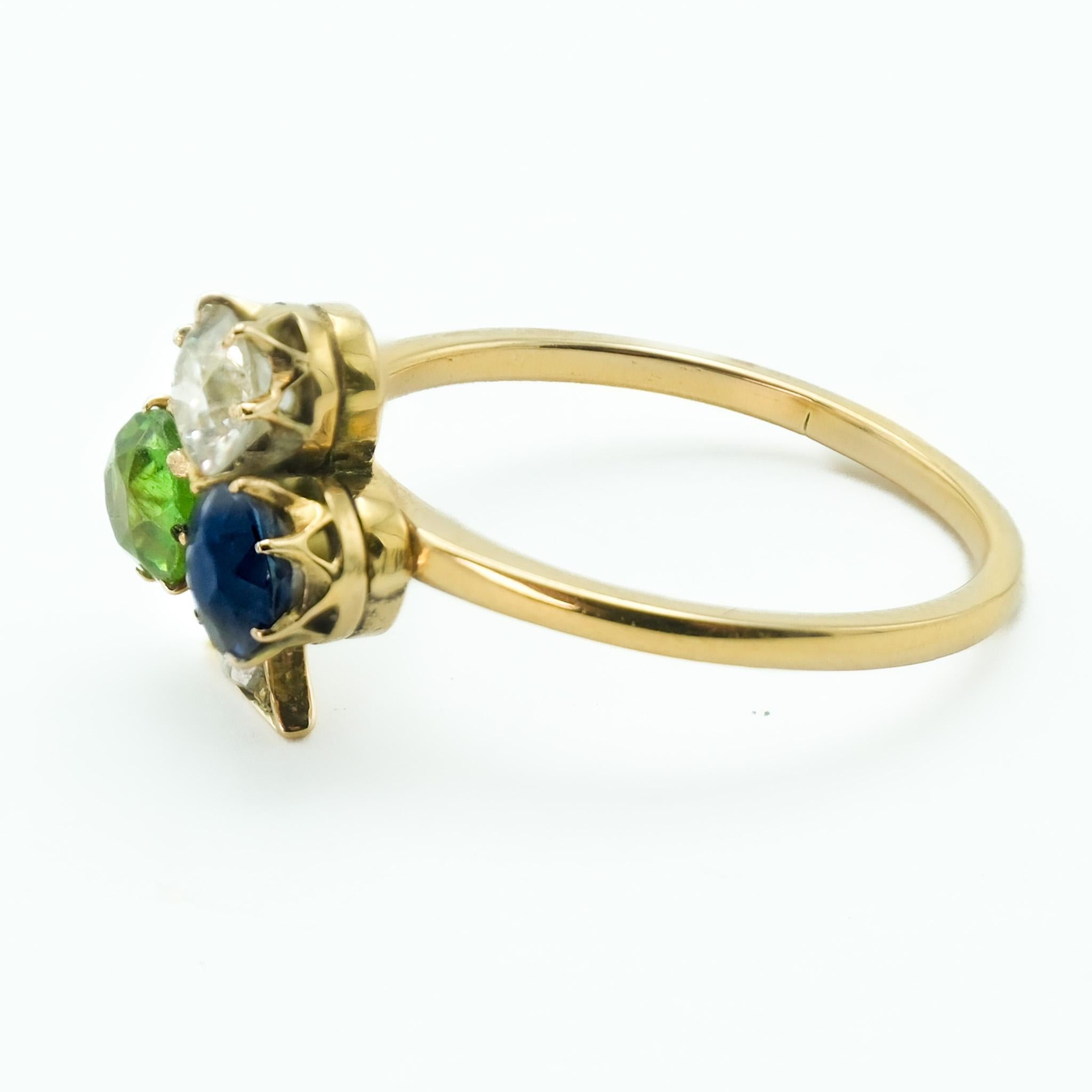 As a representation of elegance and serendipity, this 18 karat yellow gold ring showcases a clover emblem - a symbol historically associated with good fortune and prosperity. 

At the heart of this design are three distinguished gemstones -