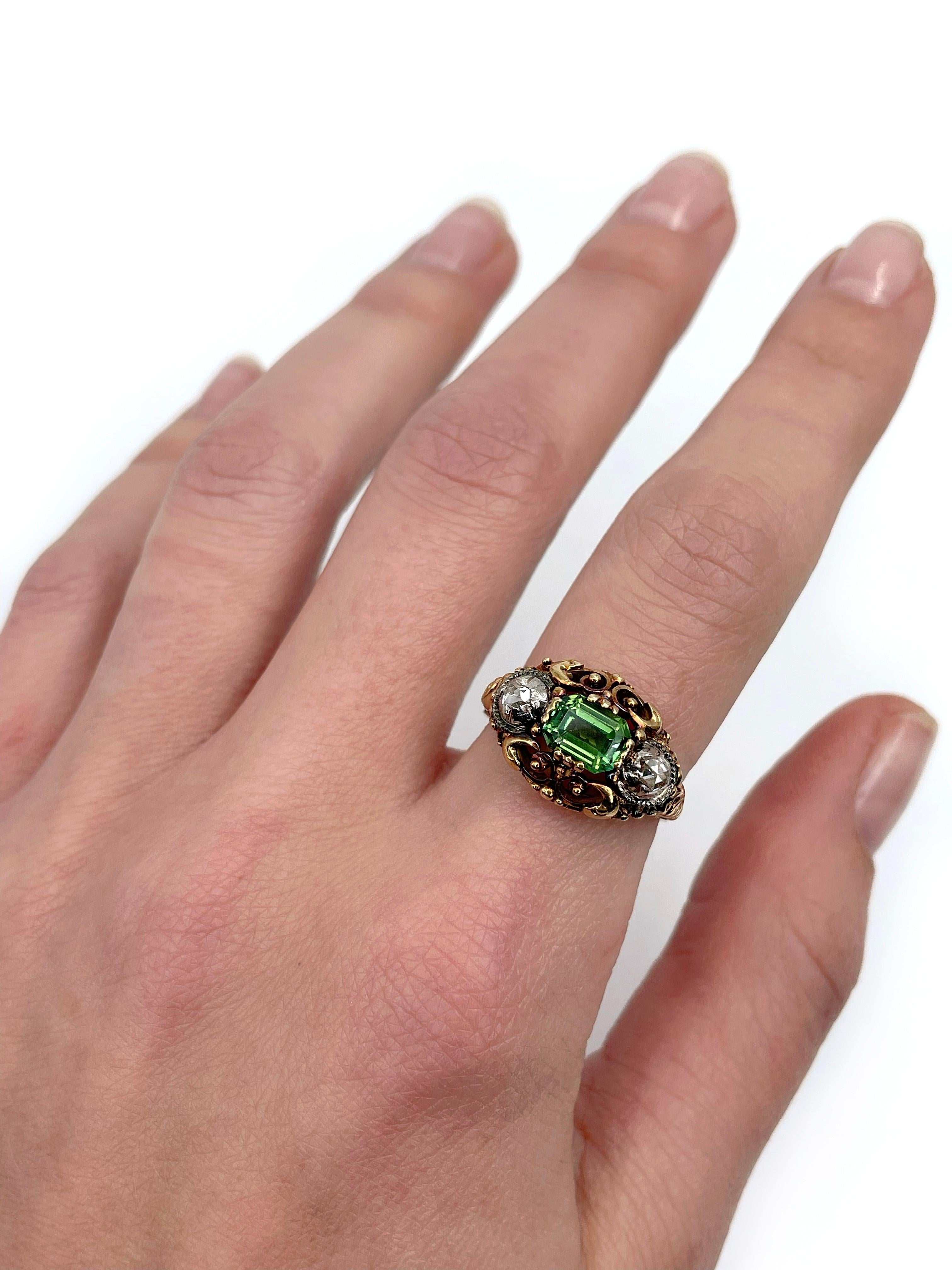 This is a stunning Victorian three stone ring crafted in 18K gold. Circa 1880. The piece features beautiful green rectangle shape tourmaline. It is paired with two rose cut diamonds. The ring is highly decorated. 

Weight: 5.47g 
Size: 17.25 (US