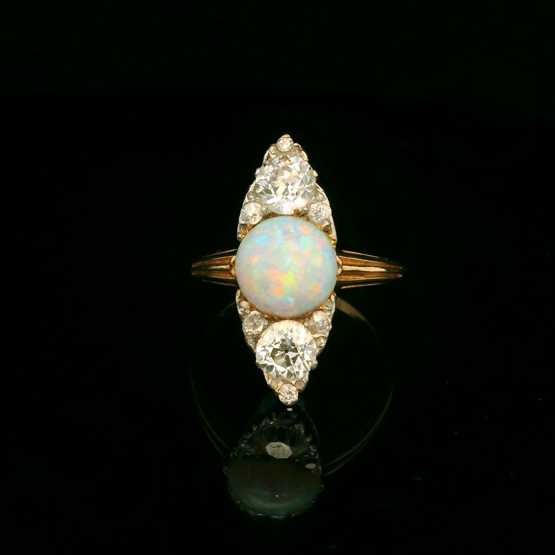 Victorian Navette ring circa 1890- 1900. 

The ring si set with a beautiful opal, 2 main old European cut diamonds for a total of approximately 1.30 Carats and 6 small old European cut diamonds. 

Color of the diamonds: Estimated H/I 

Clarity of