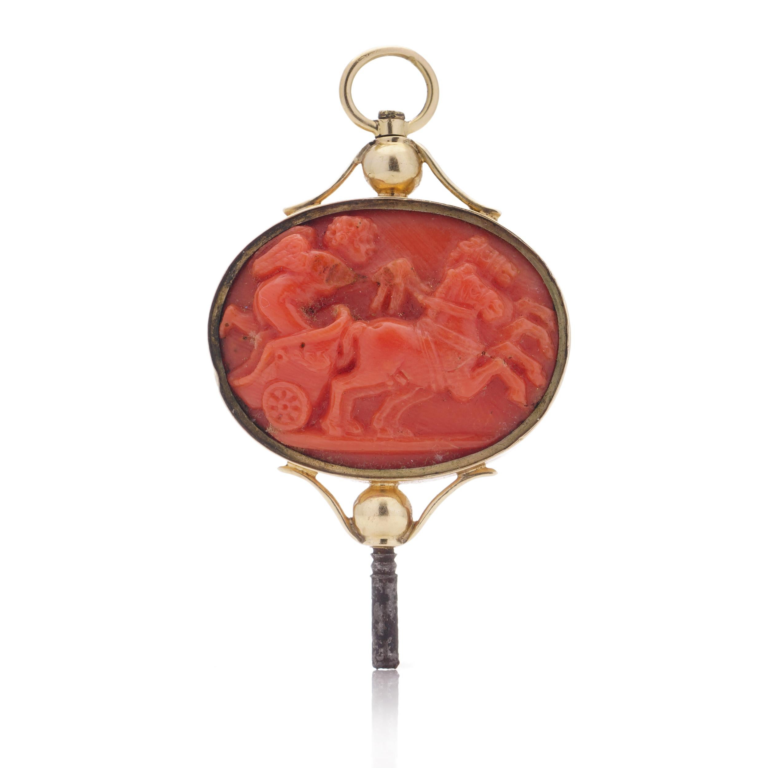 This exquisite Victorian pocket watch key/pendant is crafted from 18k yellow gold and adorned with a meticulously carved coral design. The pendant showcases neoclassical scenes on both sides, each depicting a captivating narrative. On one side, a