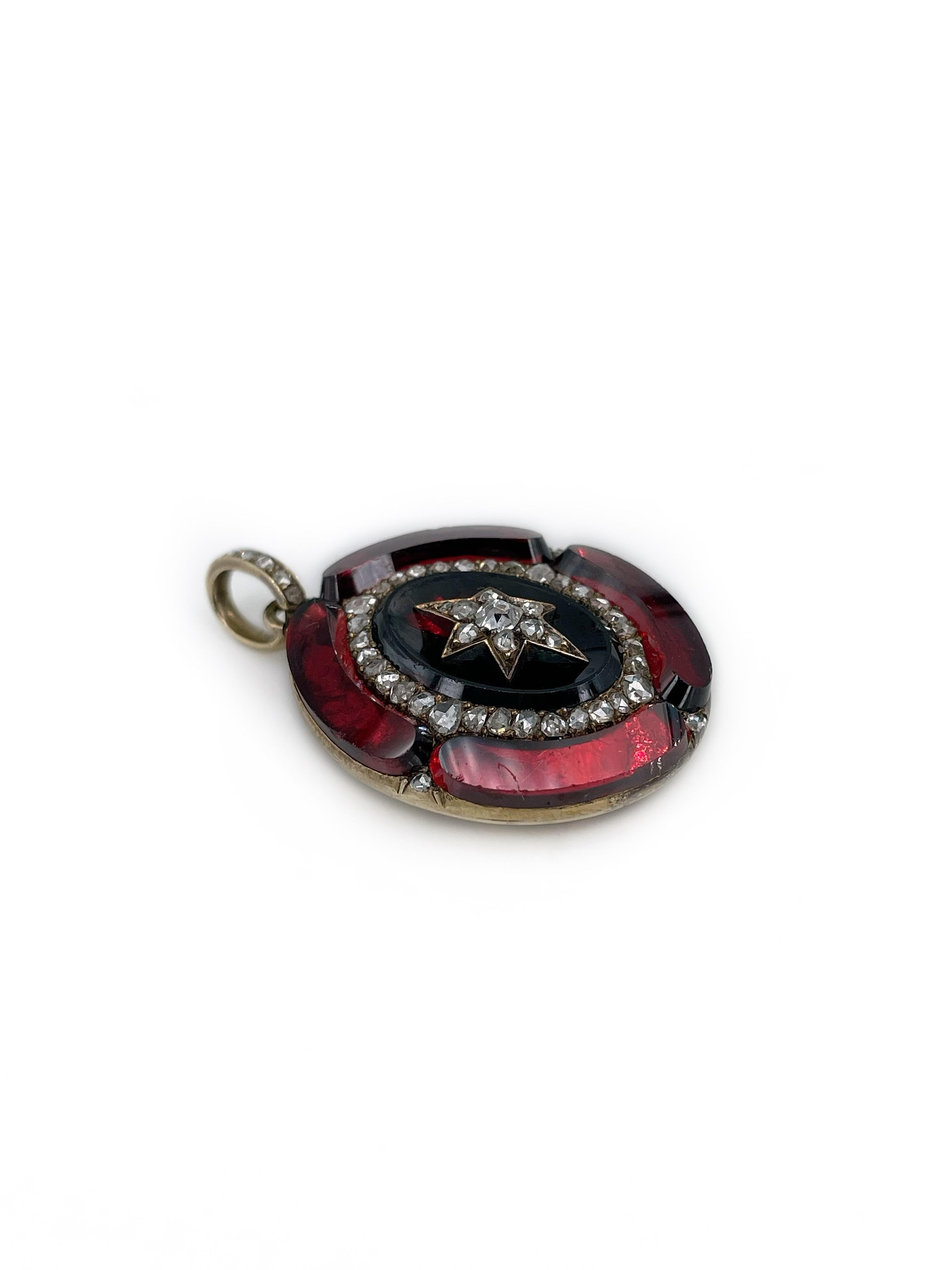 This is a gorgeous Victorian oval pendant crafted in 18K gold. It features polished garnets and rose cut diamonds. There is a six pointed star in the centre. 

The back side with the glass doesn’t open. 
 
Circa 1860

Weight: 13.24g
Size: