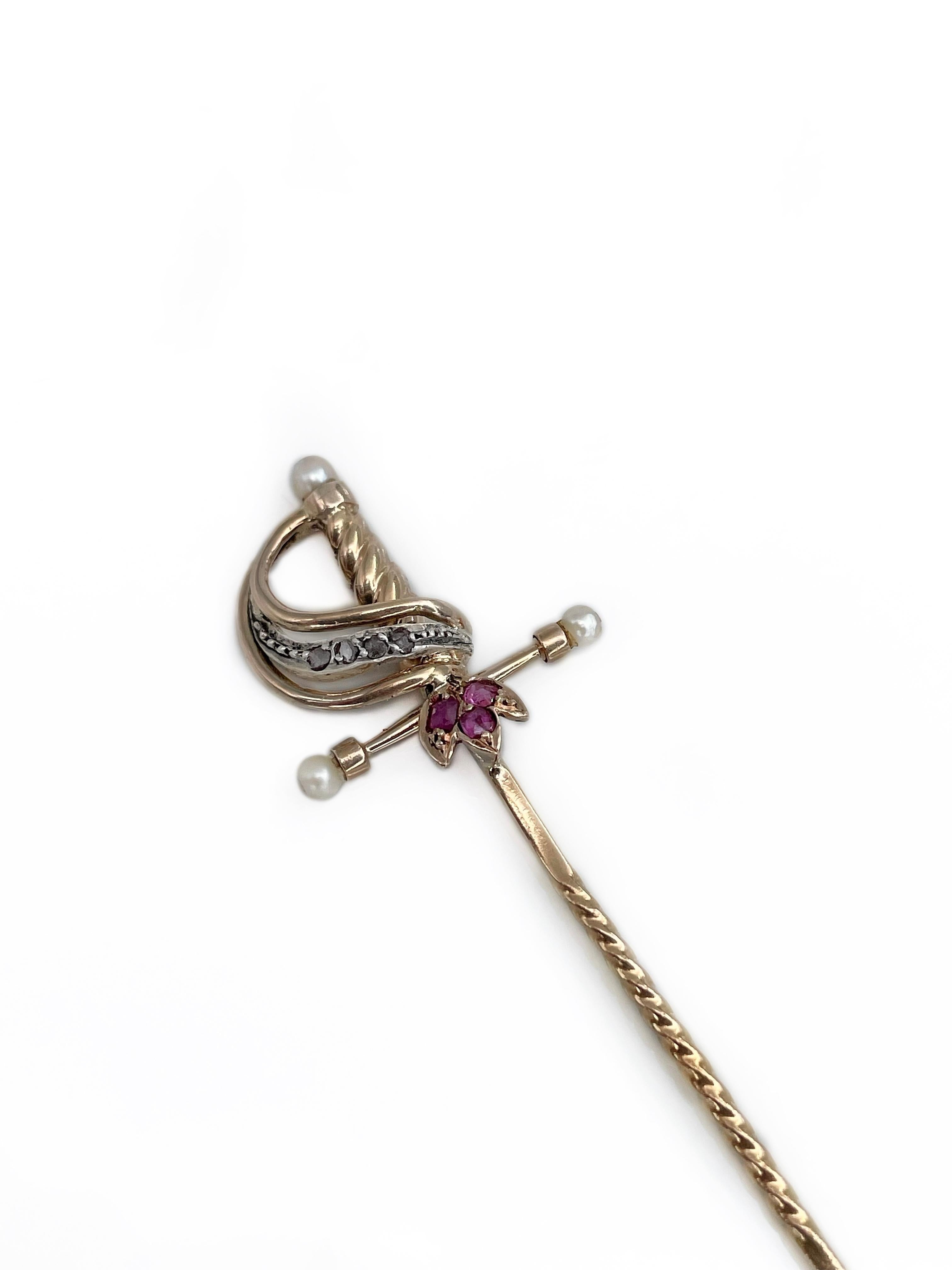 This is a Victorian bejeweled sword stick pin brooch. It is crafted in 18K yellow gold. The piece features rubies, old cut diamonds and seed pearls. 

Weight: 2.22g
Length: 7.5cm
Width (at max): 1.5cm

———

If you have any questions, please feel