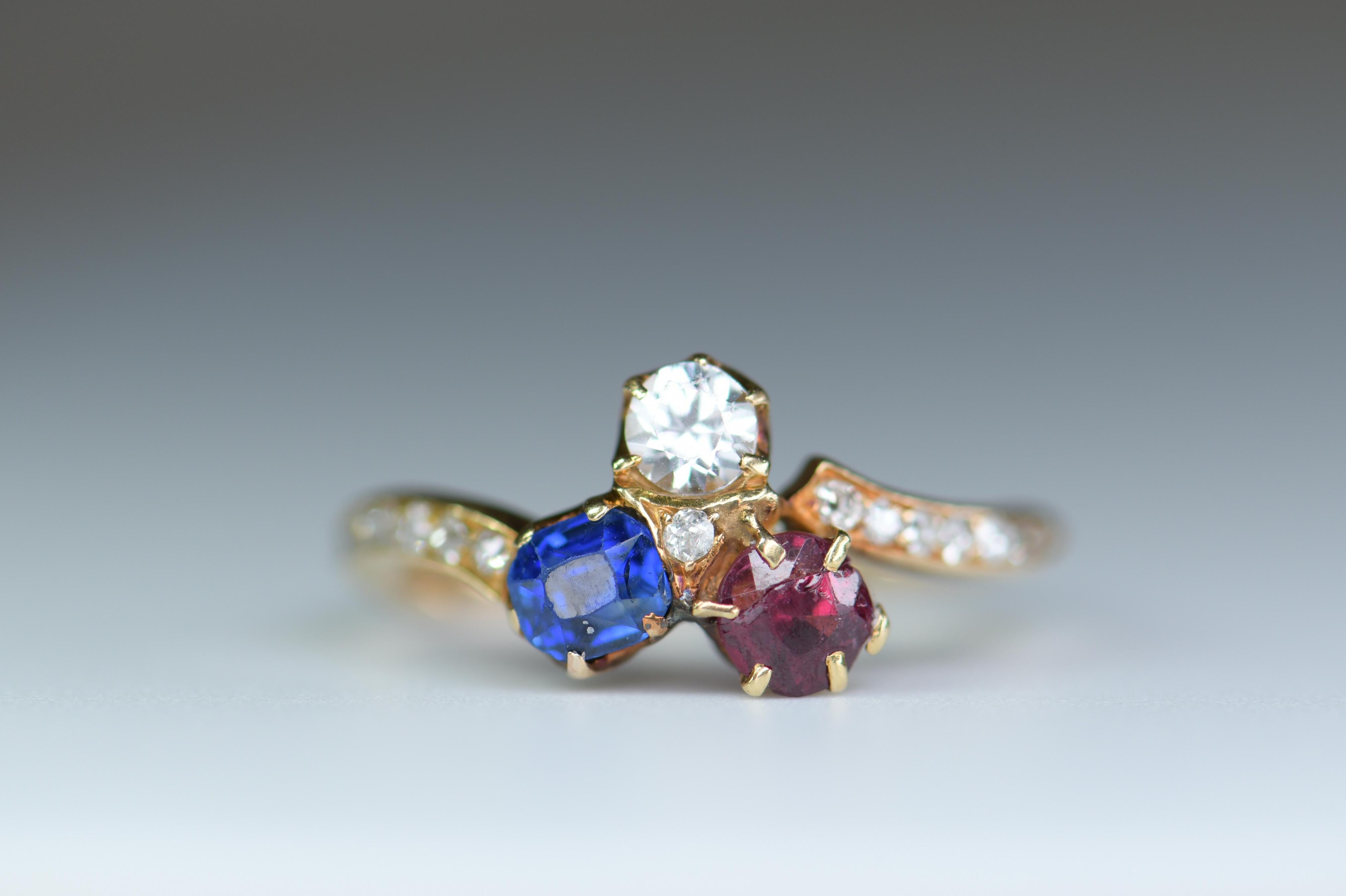 Hooray for the red (ruby), white (natural pearl) & blue (sapphire). The colorful and gemmy trio is arrayed in a lucky shamrock motif hand fabricated in 18K gold with diamond set shoulders. Classic Victorian - circa 1880. 

It is currently a size P