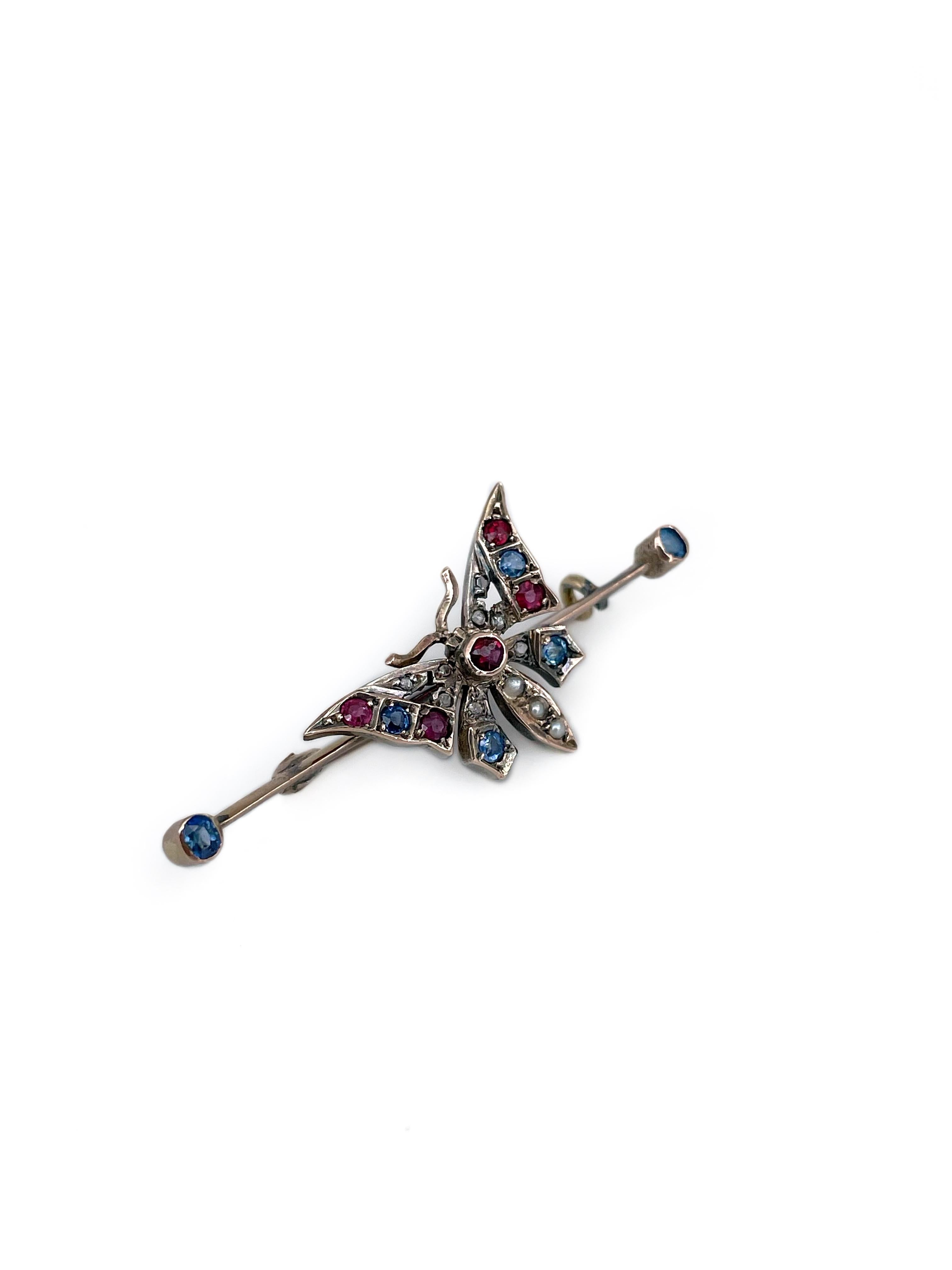This is a lovely Victorian butterfly bar brooch crafted in 18K gold. Circa 1890. 

Victorian era had an intricate language of symbolism. The butterfly symbolised beauty, transformation and soul. 

The brooch features 6 sapphires, 5 rubies, 3 seed