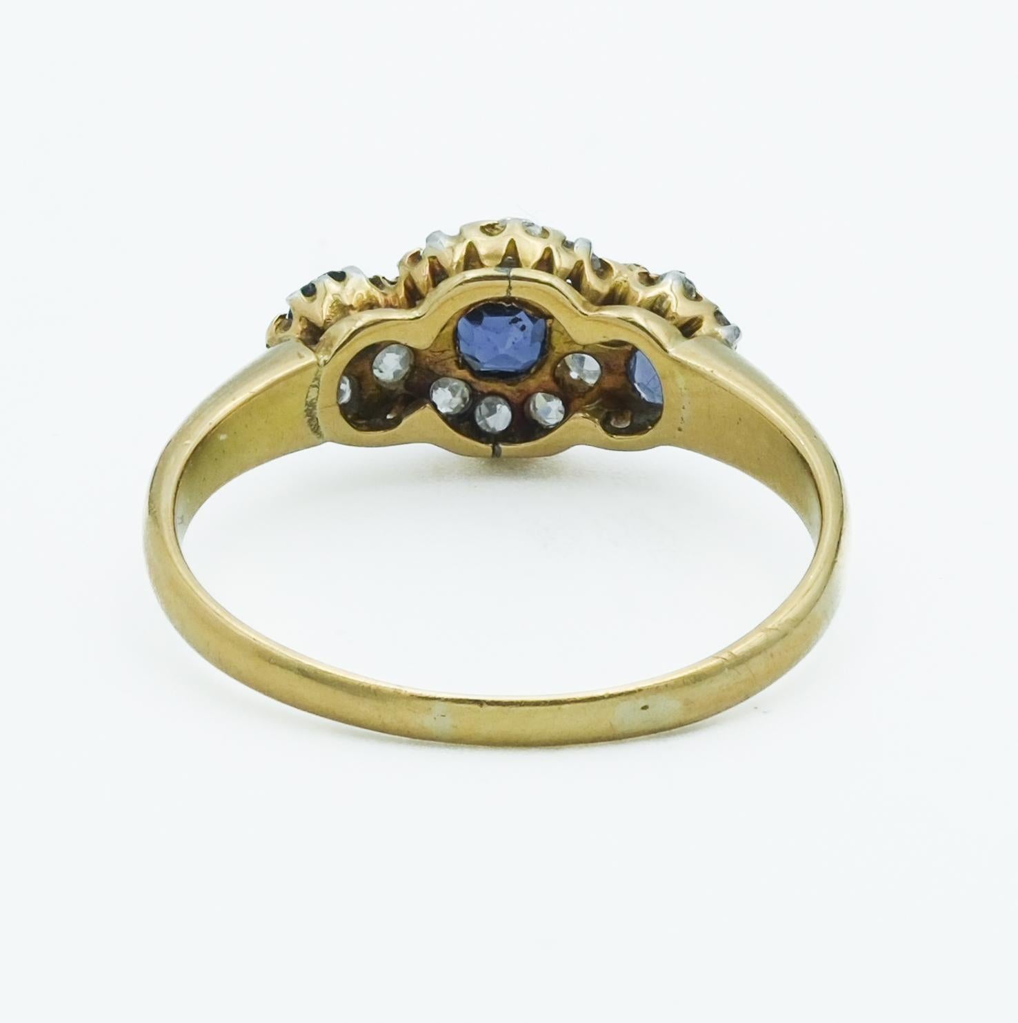 Round Cut Victorian 18 Karat Royal Blue Sapphire and Diamond Three Stone Cluster Ring For Sale