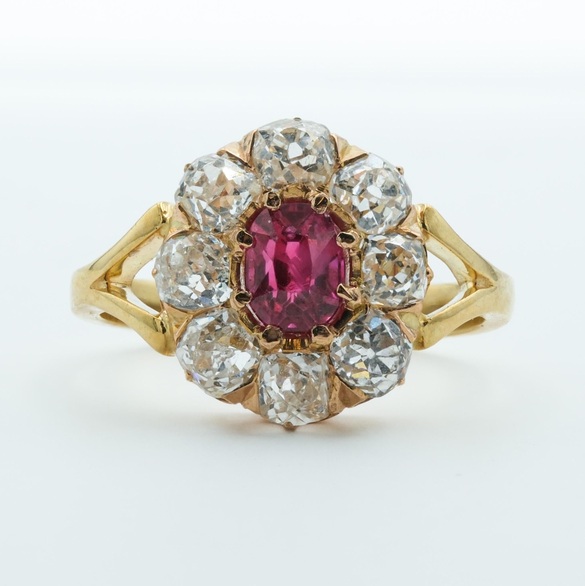 This Victorian-era ring is a resplendent piece of history, crafted from 18 karat gold. It features a central ruby weighing .82ct, a gemstone cherished for its deep, vivid color and is often associated with passion and nobility. The ruby's rich hue