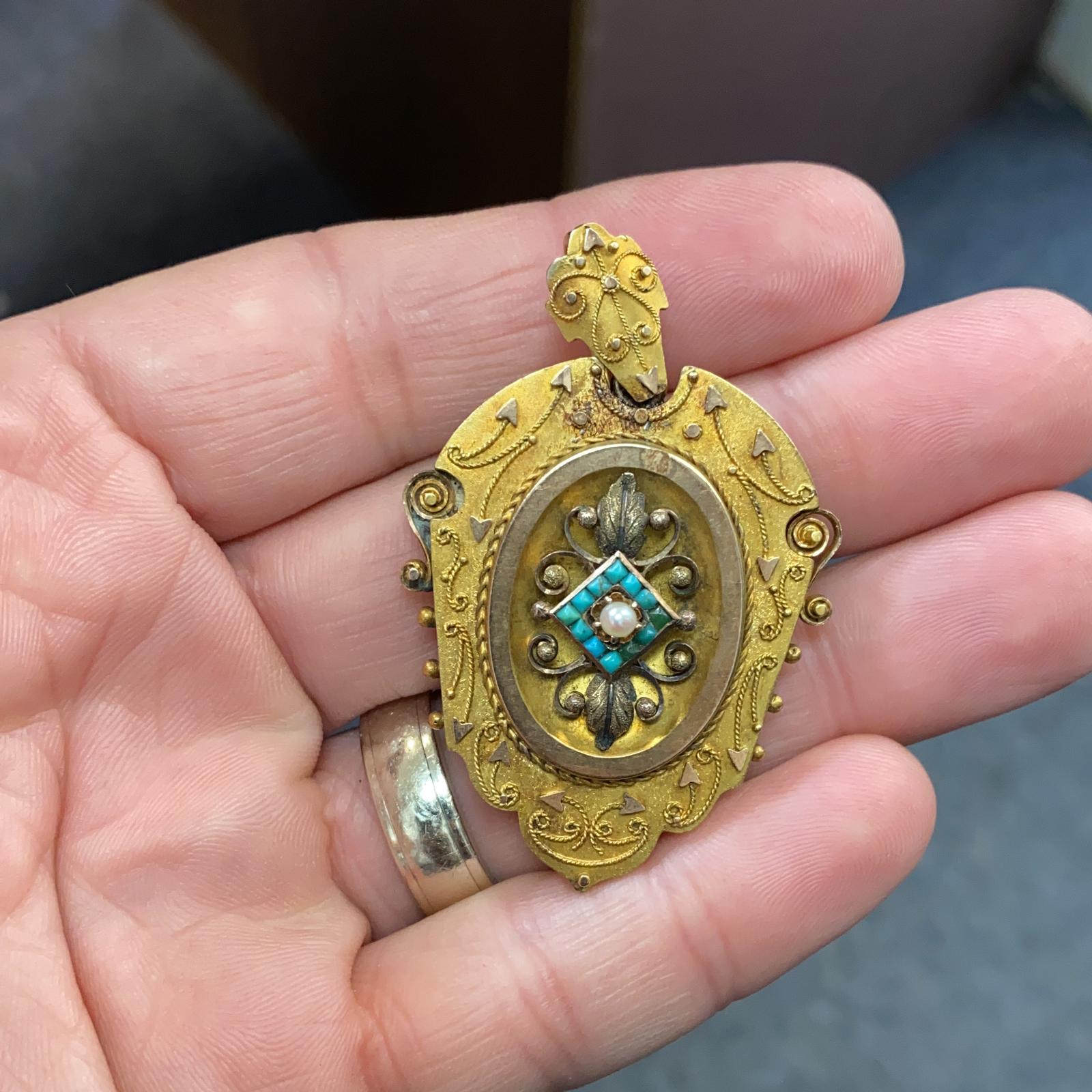 Original Victorian locket pendant fashioned in 18 karat yellow gold. The hand crafted pendant features turquoise and seed pearl accents, and measures 2.25 x 1.50 inches. 
