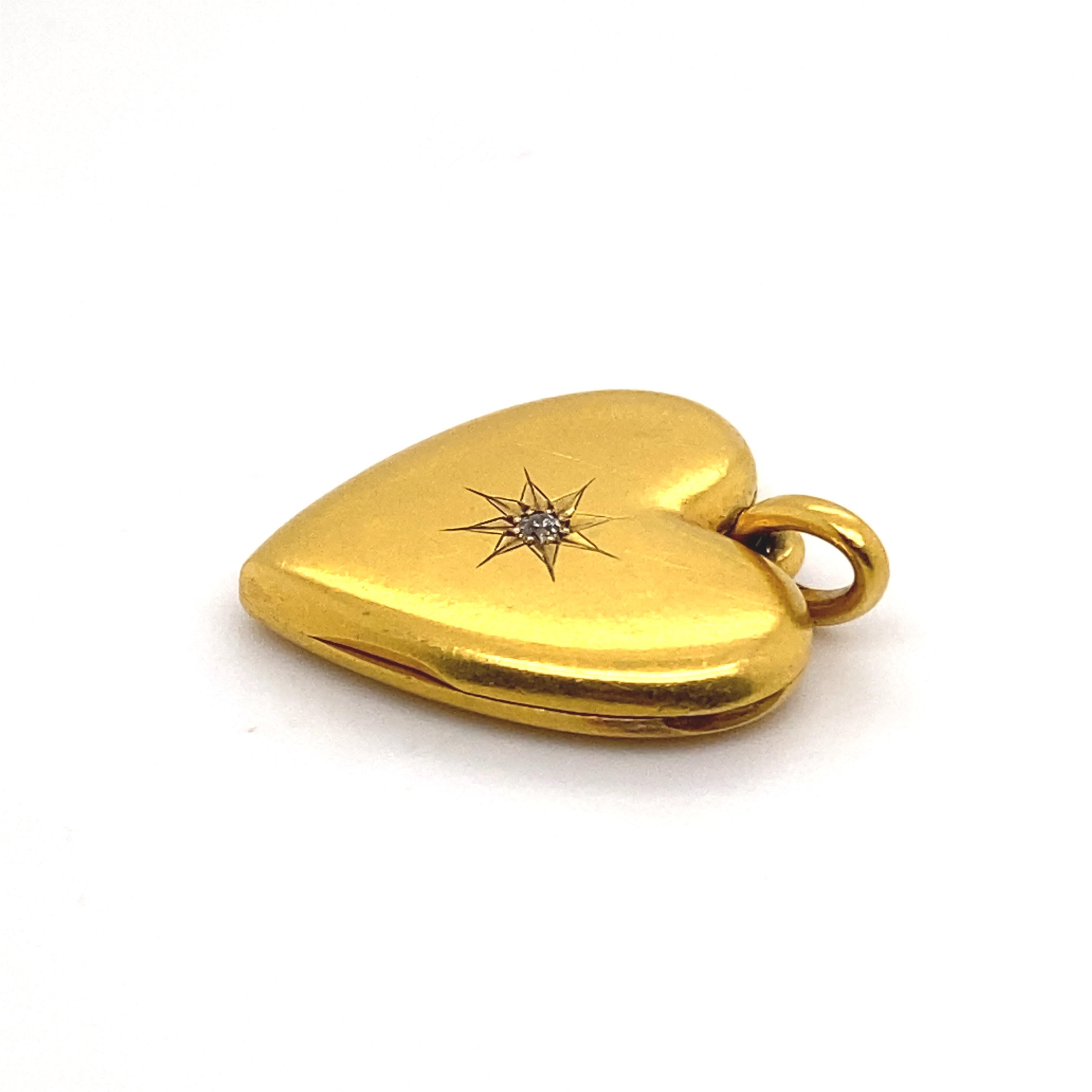 A Victorian 18 karat yellow gold diamond heart locket pendant.

This sweet heart shaped locket pendant, features a single star set old cut diamond of 0.02 carats approximately, G-H colour, VS1 clarity.

The heart locket is hinged and memorial glass