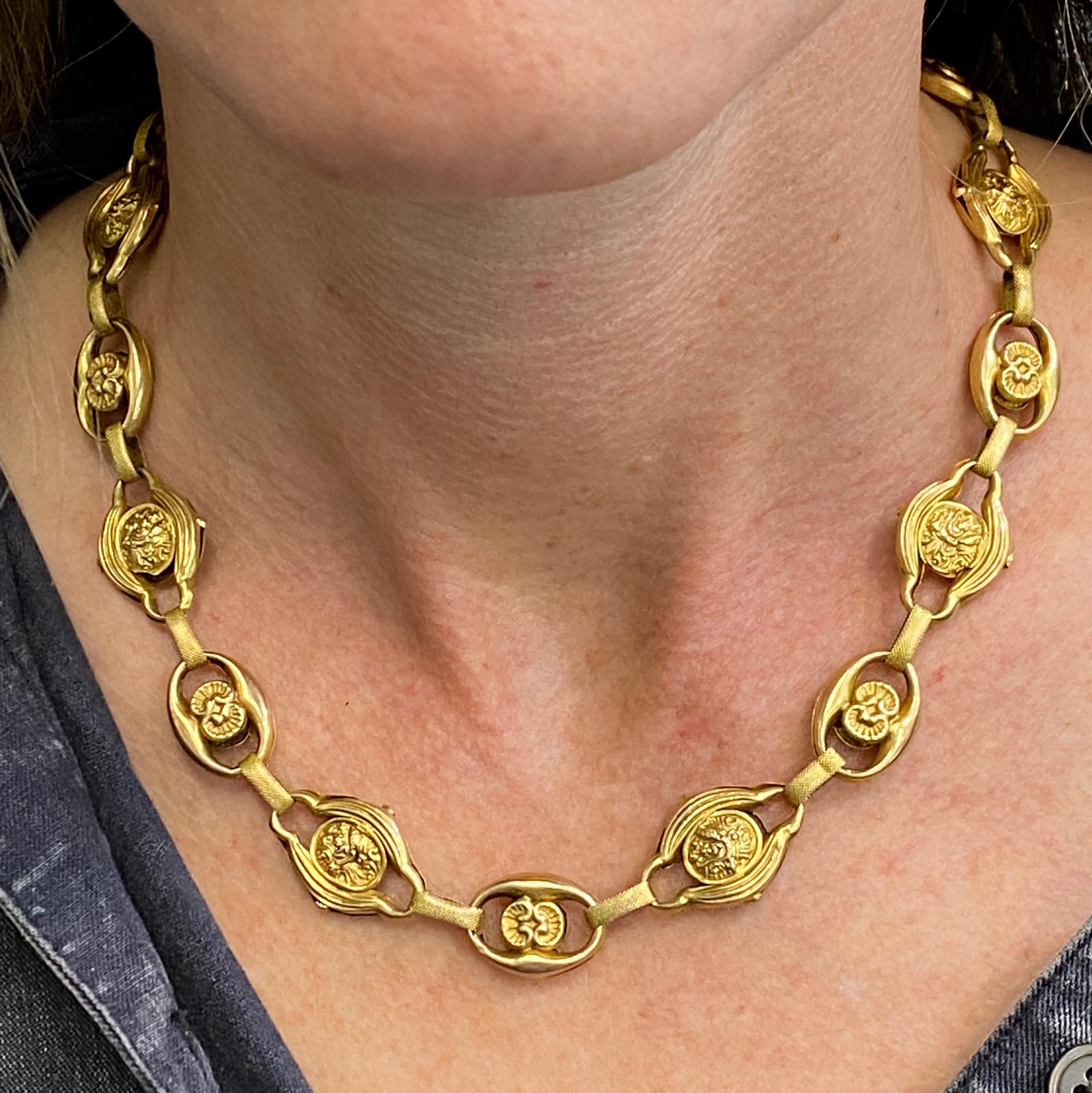 Victorian link necklace fashioned in 18 karat yellow gold. The lightweight antique necklace features open handcarved links and measures 16.5 inches in length. 