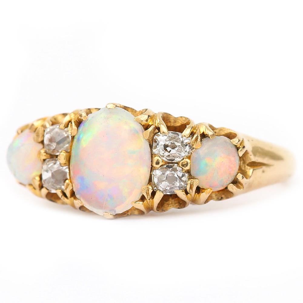 A delightful Victorian 18 Karat yellow gold opal and diamond seven stone gypsy ring. All the gemstones are claw set with the opals displaying some good ‘fire’ within the stones. The diamonds are old mine cut diamonds typical of this particular era,