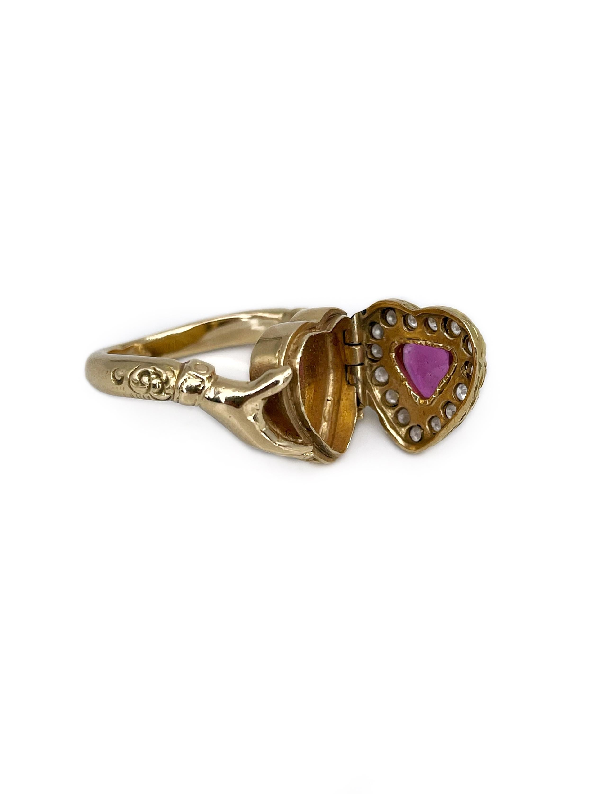 This is a stunning antique Claddagh locket ring crafted in 18K yellow gold. The piece features beautiful ruby. The gem is surrounded by diamonds. 

This ring could be an extraordinary choice for your engagement. 

Weight: 11.41g
Size: 16.5 (US