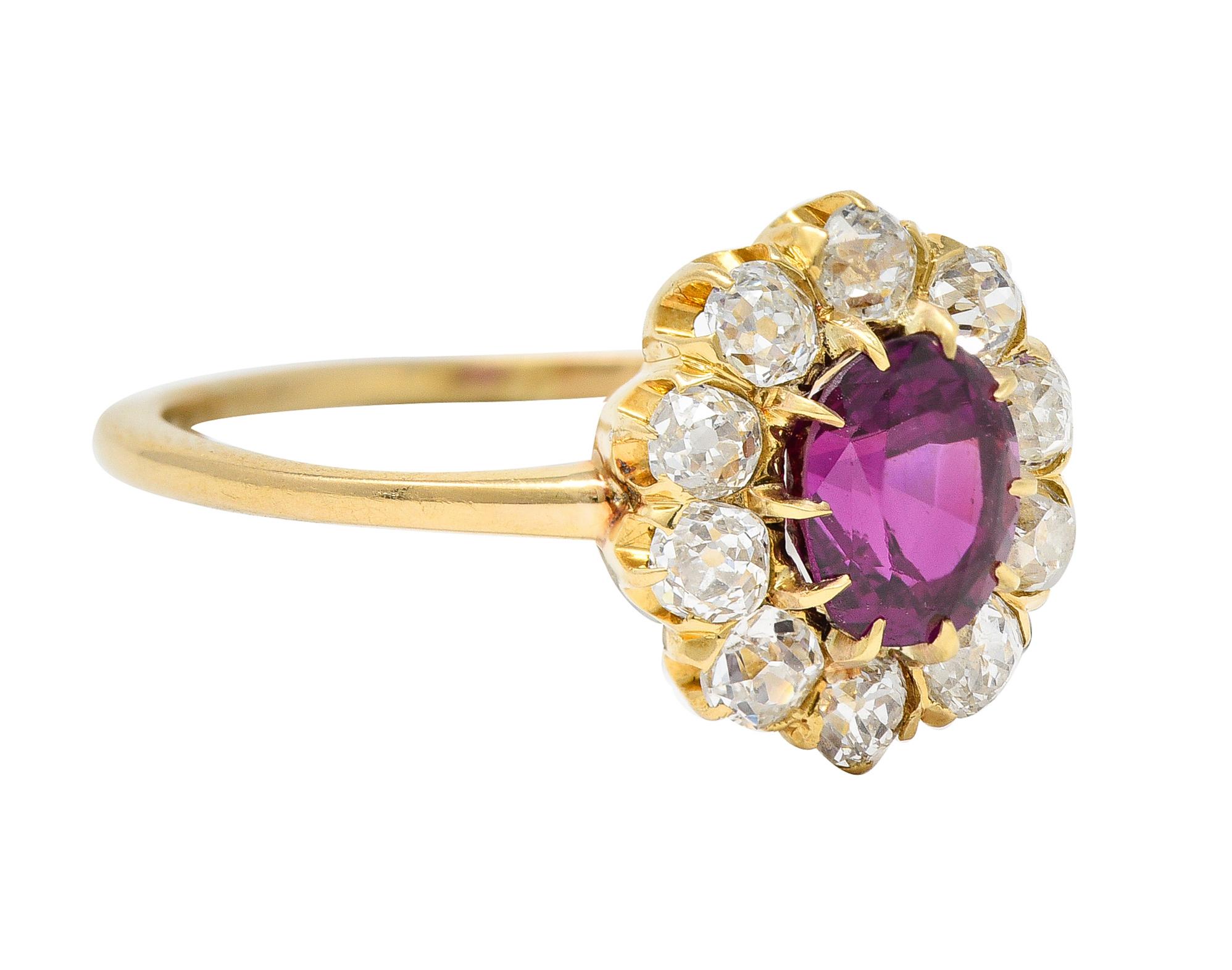 Centering an oval cut ruby weighing approximately 1.22 carats - transparent medium purplish red. Set with talon prongs with a cluster surround of old mine cut diamonds. Weighing approximately 0.60 carat total. I/J in color - clarity consistent with