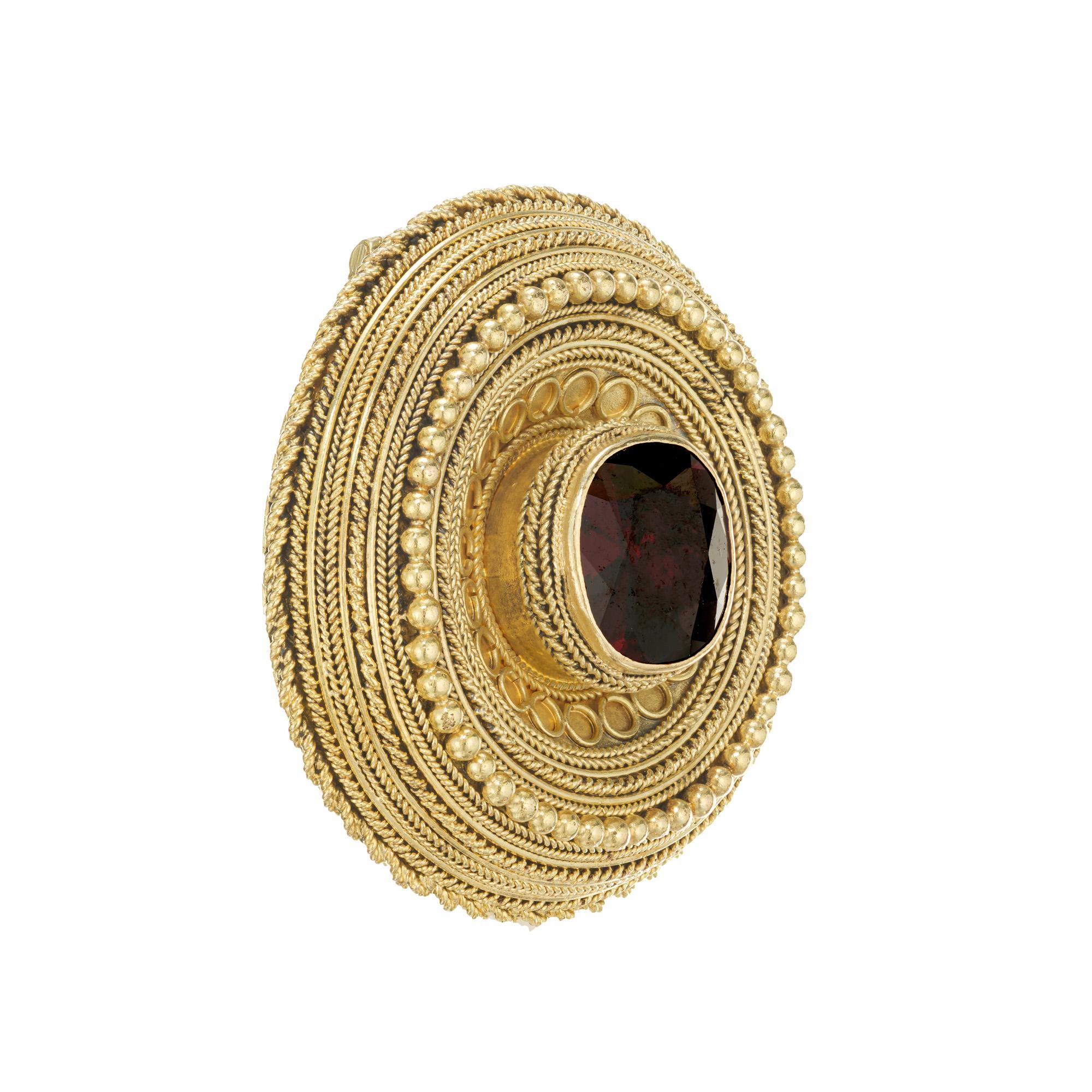 Handmade garnet brooch. One cushion cut deep red, almost brown 2.20cts garnet set in a 14k yellow gold setting. This brooch is a perfect example of the crafting skills in mid to late 19th century, using a different form of twisted wire and band