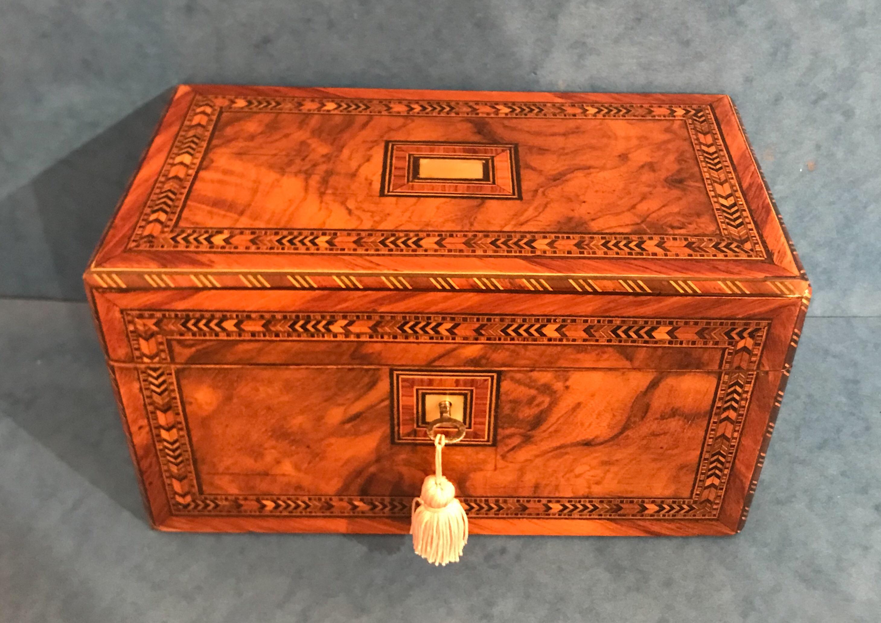 This is a Victorian 1870 walnut inlaid tulipwood Tunbridge ware twin lidded tea caddy. It has a mahogany interior and to the exterior a mother of pearl top and key escutcheon. It is in superb condition but a note of caution, it has a temperamental