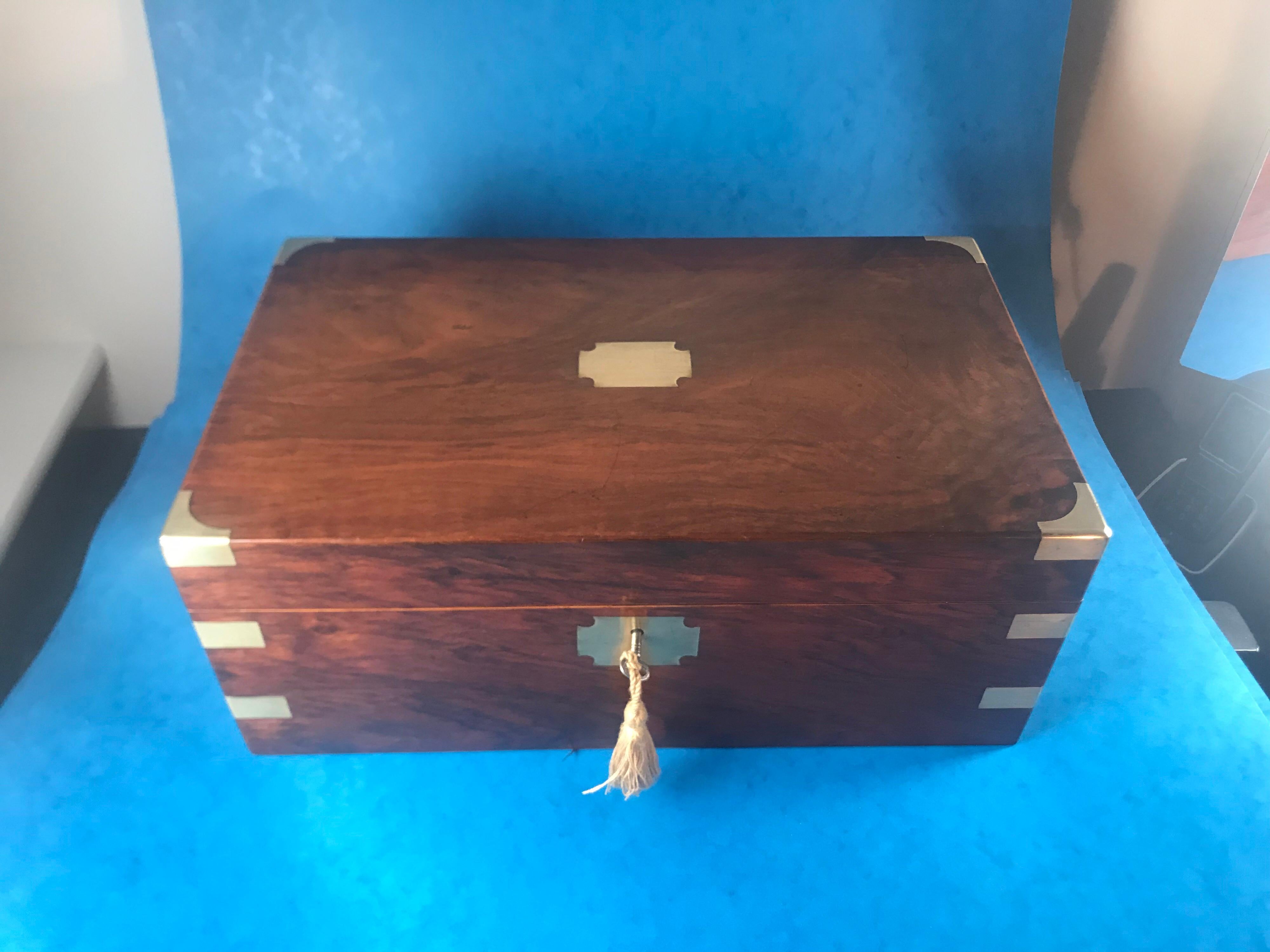 A Victorian 1880 Brass bound Walnut Writing slope, in superb original condition, with its original leather slop, two brass topped inkwells and superb secret drawers inside that work of a spring, it has a nib slope and pen slope and a working lock