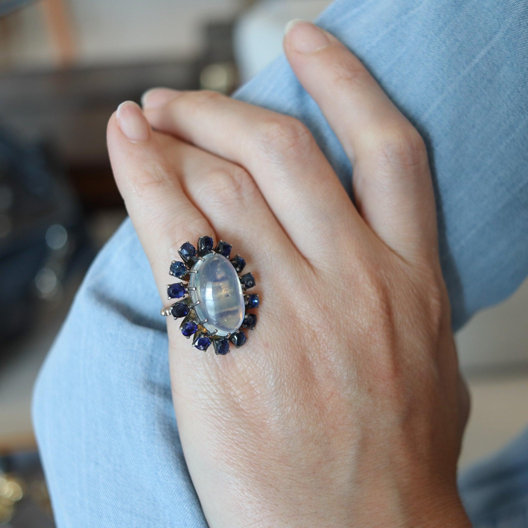 Victorian cocktail ring with a moonstone.

A statement cocktail ring, created in England during the late Victorian period, back in the 1880. The ring has been crafted in solid gold of 10 karats with silver accents for the settings of the gemstones.