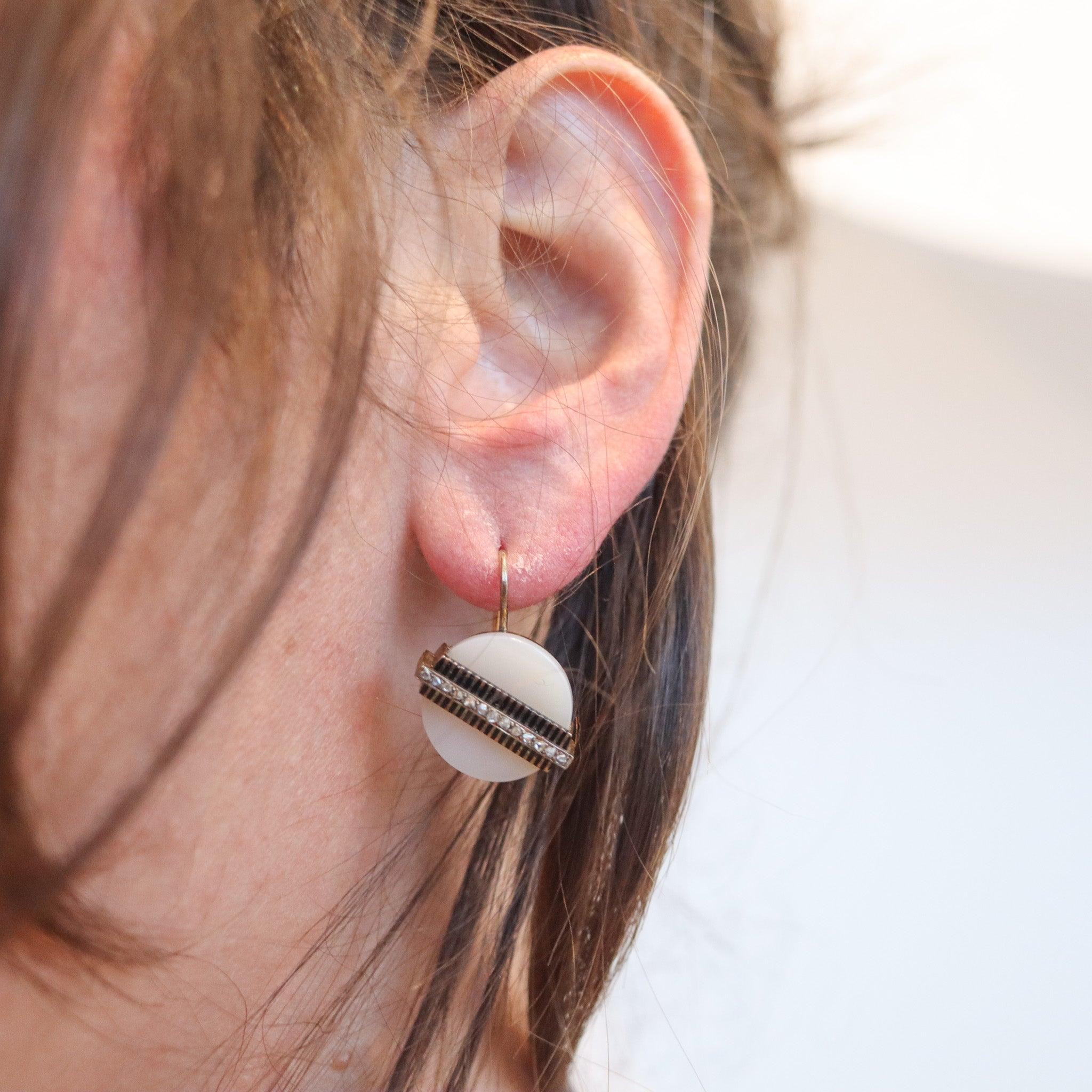 Victorian industrialism dangle earrings with a agate

This is an industrial-shaped pair of dangle earrings created in England during the late Victorian period, between the 1870 and 1880. The unusual earrings have been crafted with a mechanical