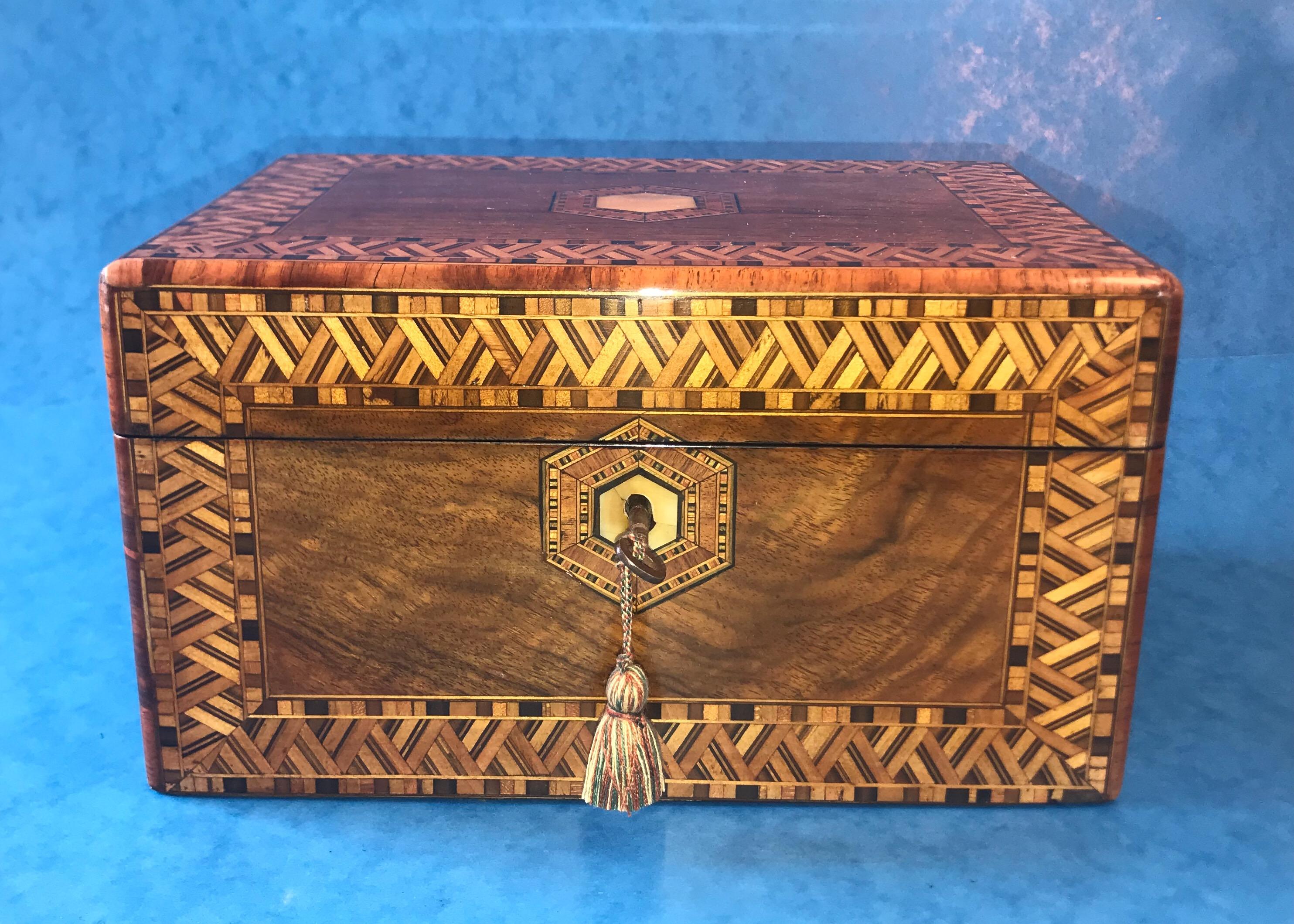 Victorian 1880 inlaid walnut Tunbridge ware box. It is striking and one of a kind with hexagon inlaid MOP centre to the top and key escutcheon. Open the box to reveal an ebony slip to the inside and the internal lid and base professionally relined