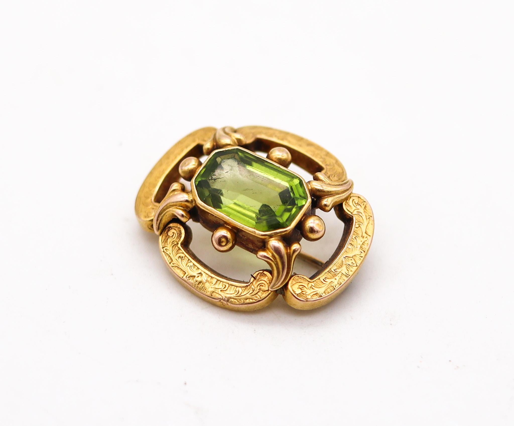 Victorian brooch with green peridot.

Beautiful pin brooch, created in London England during the Victorian period, back in the 1880. It was crafted with neo gothic motifs in yellow gold of 14 karats with incised and  engraved decorations. Fitted at