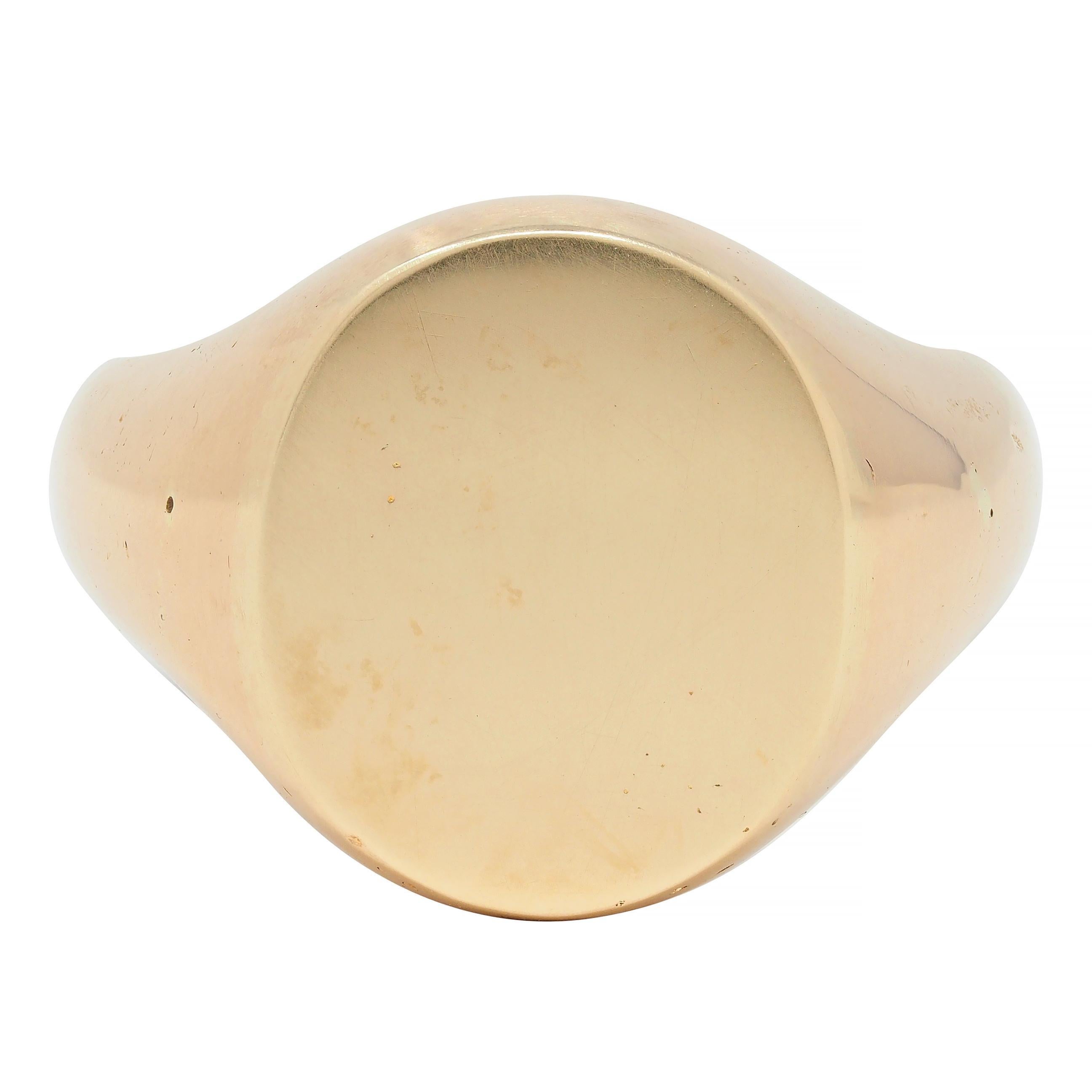 Signet style ring centers a high polish oval-shaped face
Foldable hidden key originally used for a jewelry box  
Featuring fluted shoulders 
Tested as 14 karat gold
Circa: 1880's
Ring size: 6.5 and sizable
Measures: North to South 14.5 mm and sits