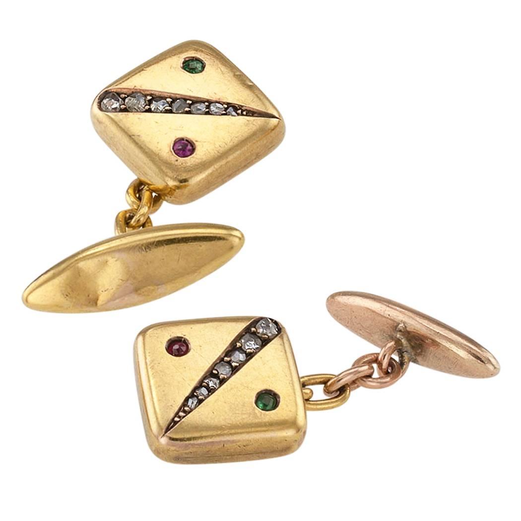 Victorian 1890s gold cuff links with rose-cut diamonds emerald and ruby .  The square rectangular-shaped  designs are decorated by a recessed course of graduating rose-cut diamonds balanced at either side by a single round emerald and a ruby.  One