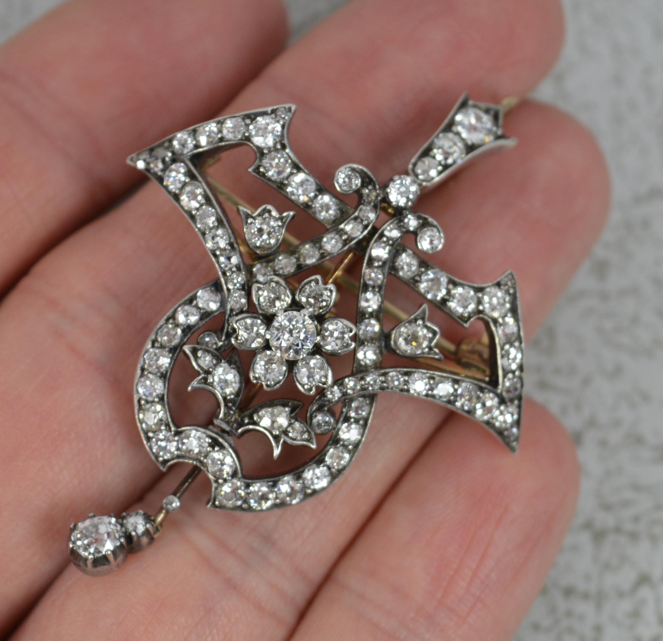 A stunning mid Victorian period pendant or brooch.
Solid 18 carat rose gold example with silver head front setting.
The piece has been expertly designed with bold lines and shaped. Encrusted throughout with high quality natural, old cut diamonds.