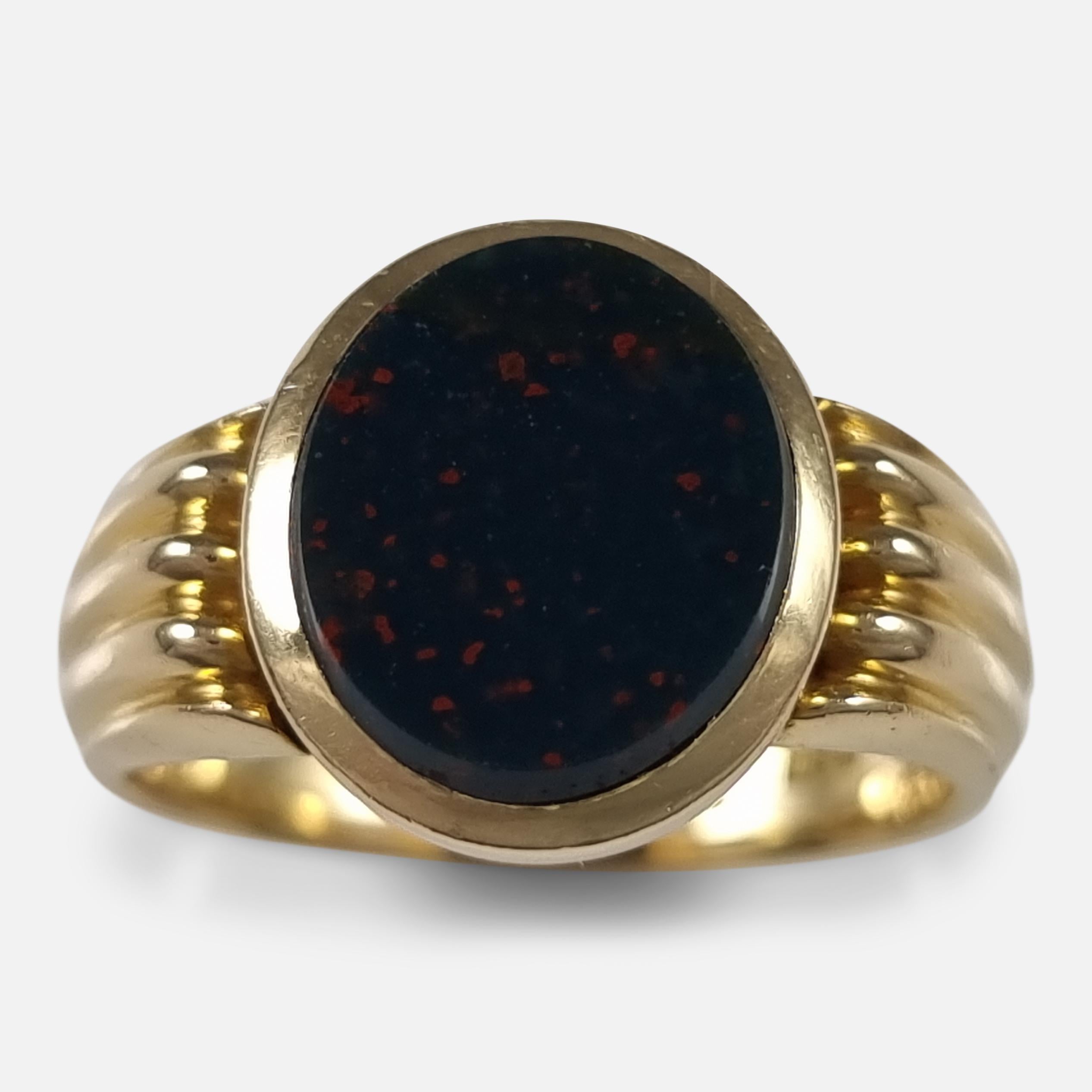 A Victorian 18ct yellow gold bloodstone signet ring. The signet ring is set with an oval bloodstone, leading to reeded shoulders, and plain shank.

The ring is hallmarked with Birmingham assay office marks, the date letter 