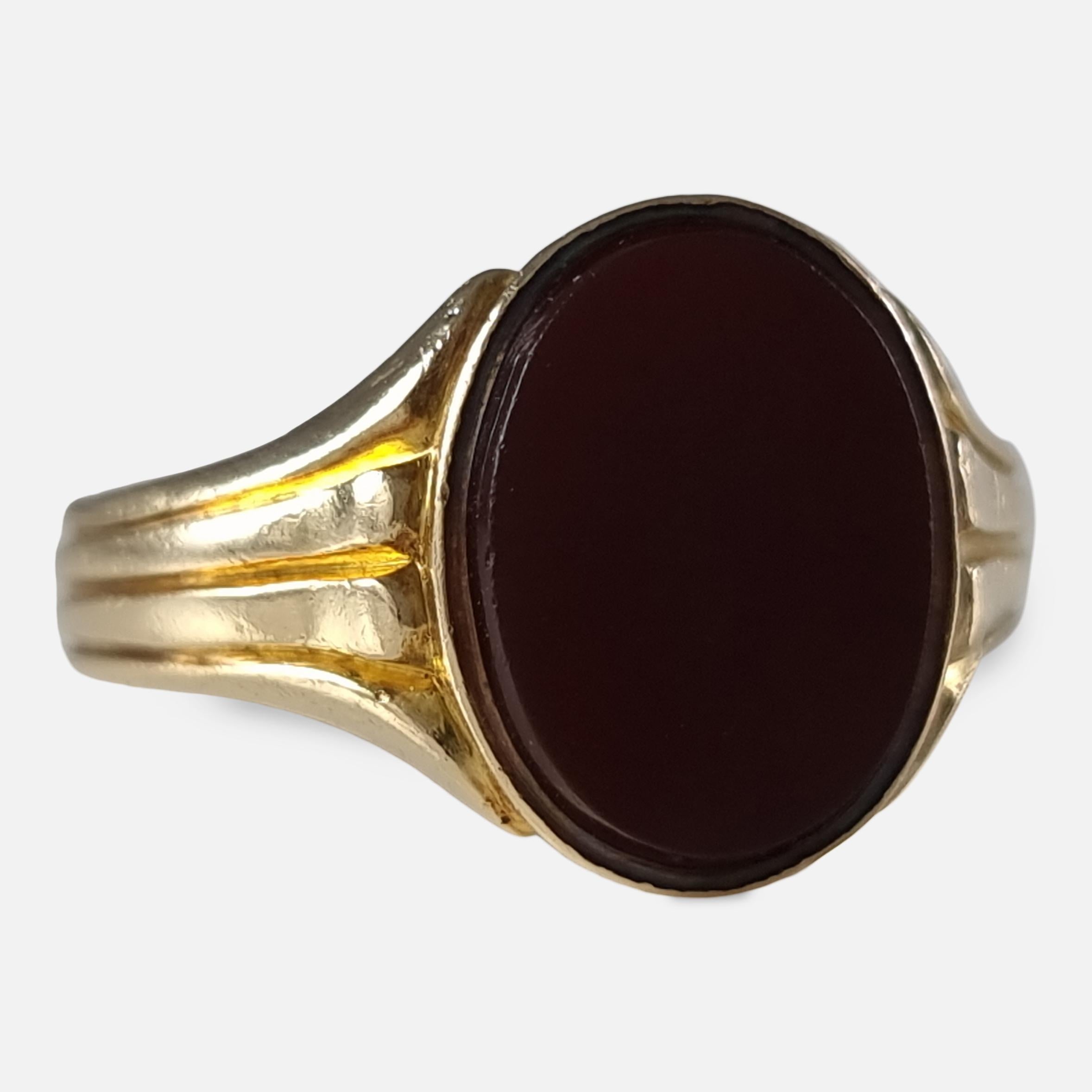 gold ring with maroon stone
