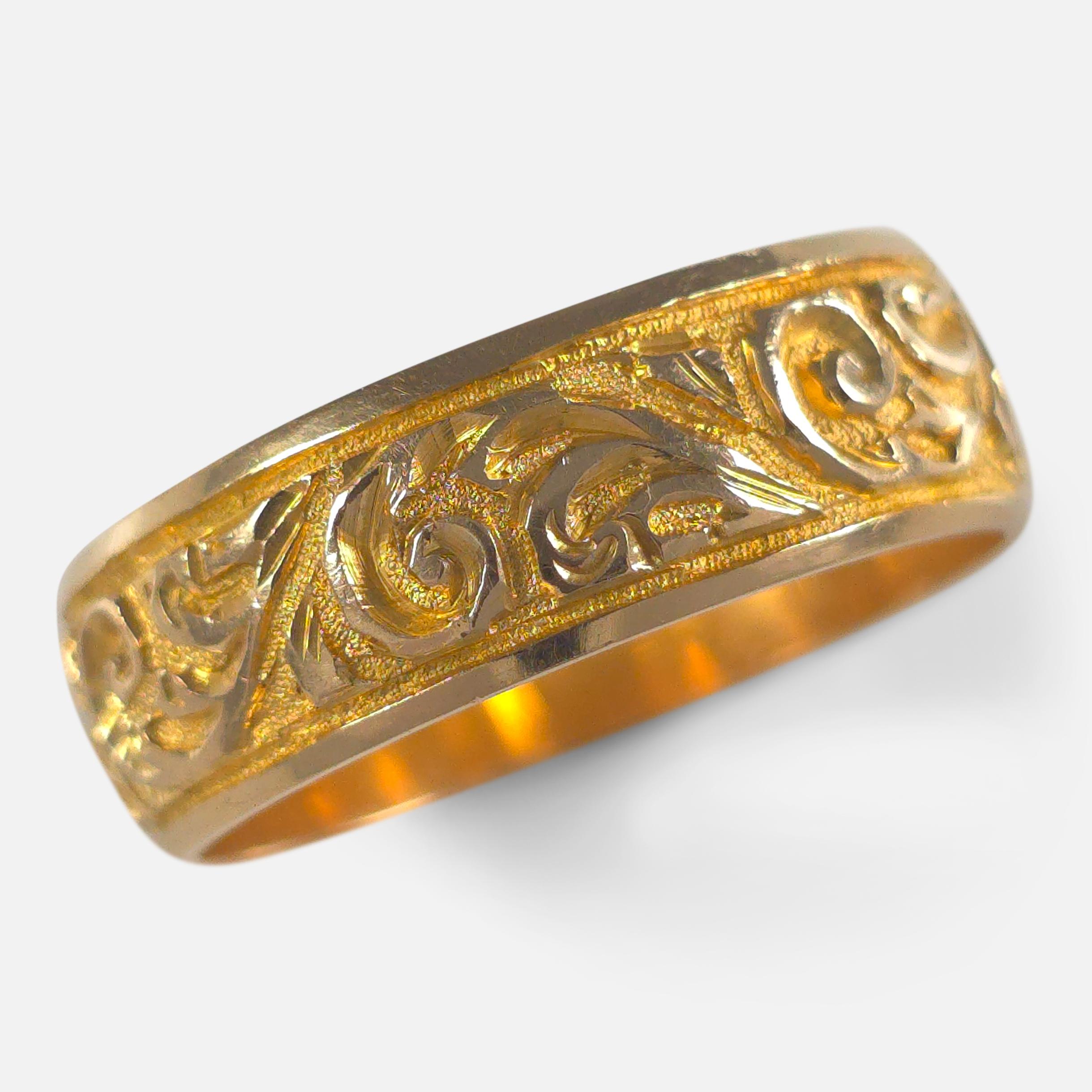 Victorian 18ct yellow gold Keeper ring, engraved with a foliate decoration, crafted in 1885 and assayed in Birmingham.

• Assay: .750 Gold (18ct), Birmingham marks.
• Period: Late 19th Century.
• Date: 1885.
• Maker: Marked 'W.M'.
• Measurement: UK