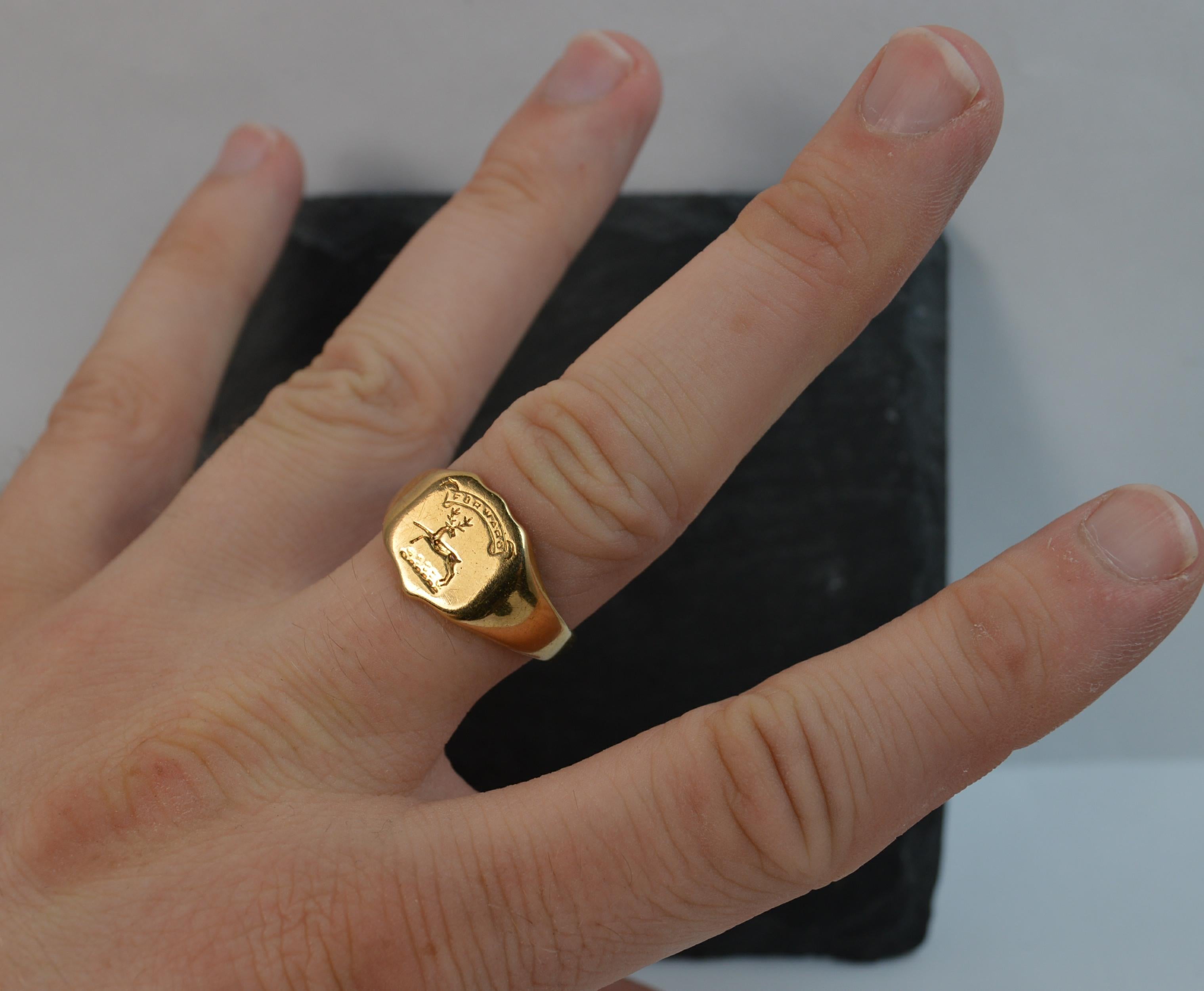 A stunning Victorian era 18ct gold signet ring.
SIZE ; T UK, 9 1/2 US, sizeable
​The 12mm x 12mm shield shaped head with banner to top with moto Forward and below a stag or deer running.
A very solid 18 carat yellow gold example.


CONDITION ; Very