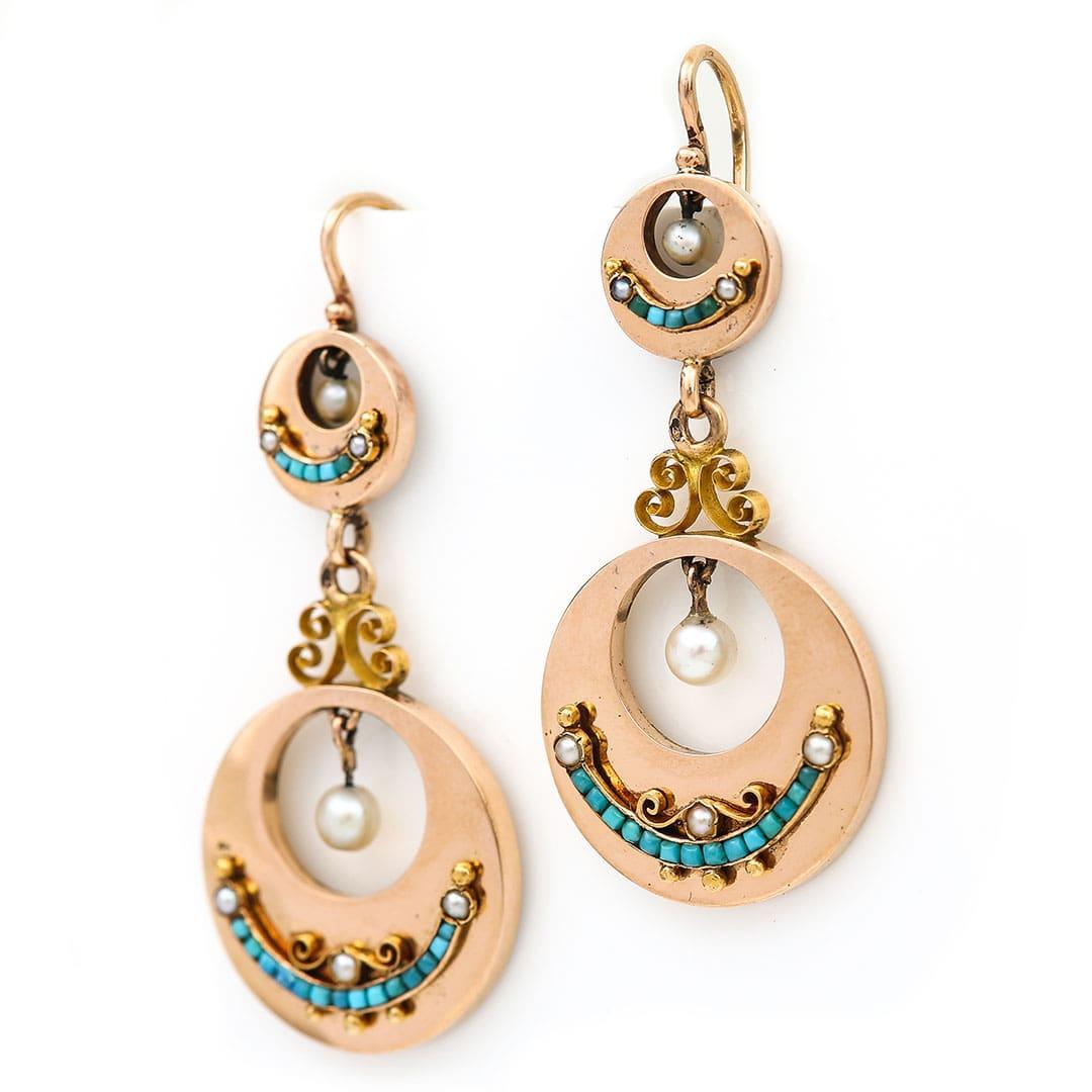 A stunning and impressive pair of Victorian French earrings which have been masterfully crafted in 18ct rose gold and date from circa 1880. The main disc drop has a crescent of cabochon turquoise that are channel set with further split pearl and