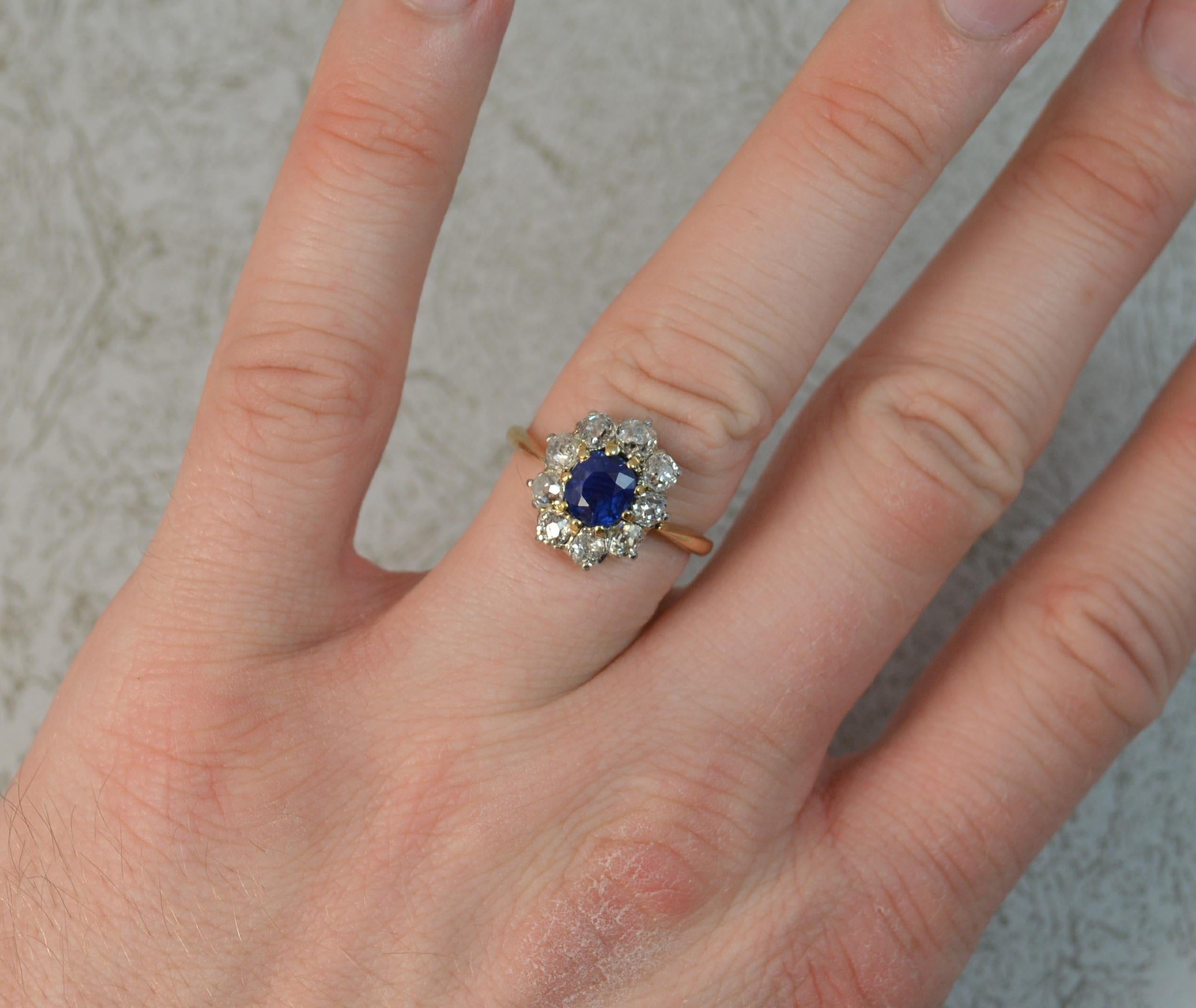 A beautiful late Victorian era cluster ring. c1890.
Solid 18 carat yellow gold shank, platinum claw setting for the diamonds and yellow gold claw setting for the sapphire.
Designed with a 1.09 carat old cushion cut natural blue sapphire to the