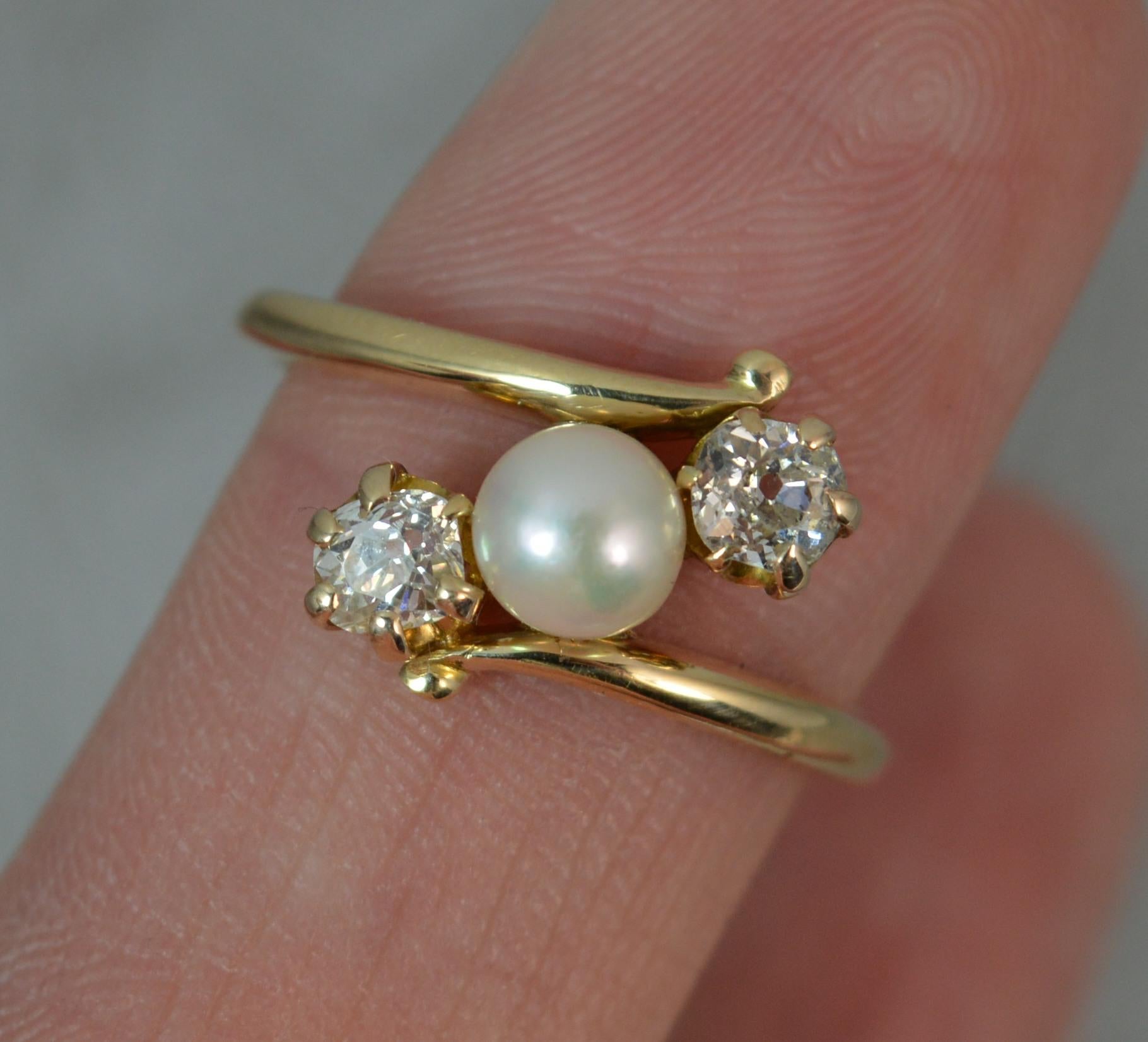 A beautiful late Victorian period trilogy ring on twist.
Solid 18 carat gold example.
Designed with a pearl to the centre and old cut diamond to each side in multi claw setting.
0.5 carat total weight, vs grade, clean and sparkly.
13mm spread of