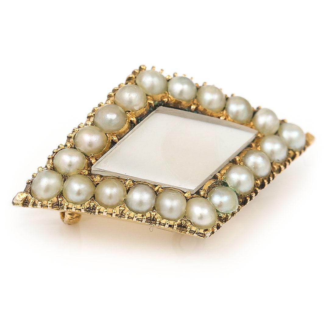 A very pretty and dainty Victorian 18ct gold pearl rhomboid shaped brooch dating from circa 1880. The masterfully crafted brooch is set with a boarder of well matched split pearls all of which are original, around a central carved pearl panel which