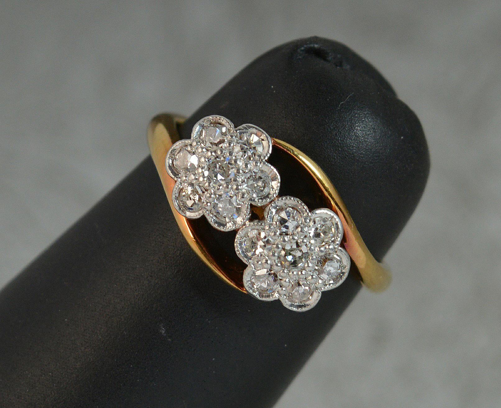 A stunning Victorian period double cluster ring. Circa 1890.
Solid 18 carat yellow gold example with platinum front head.
The head is designed as two clusters, each side with seven natural old cut diamonds in daisy shaped clusters. 0.35 carat.
13mm