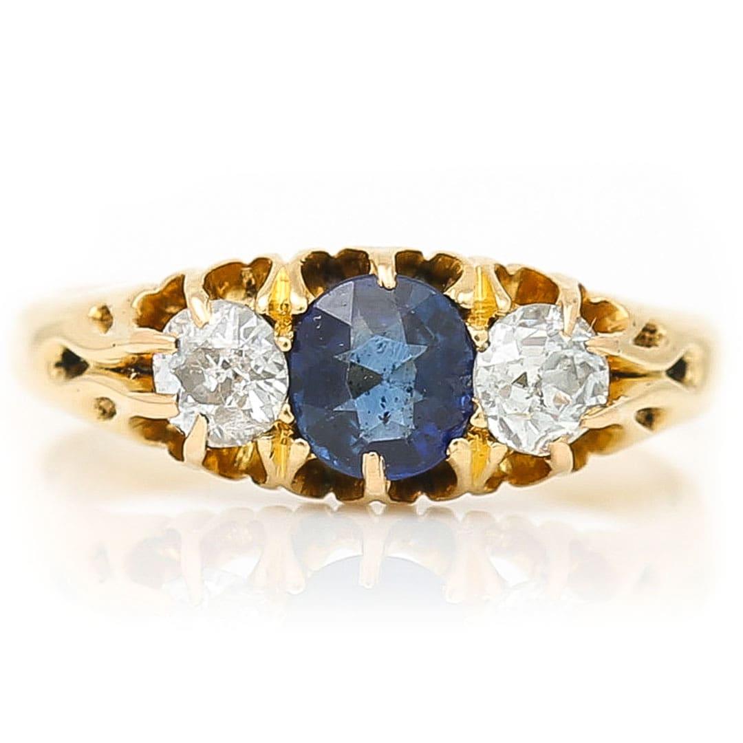 A timeless classic this Victorian 18ct gold oval cut sapphire and old cut diamond ring has all the charm and appeal of bygone era. The classic three stone design is seen throughout history as a symbol of symmetry and a token of love, life and