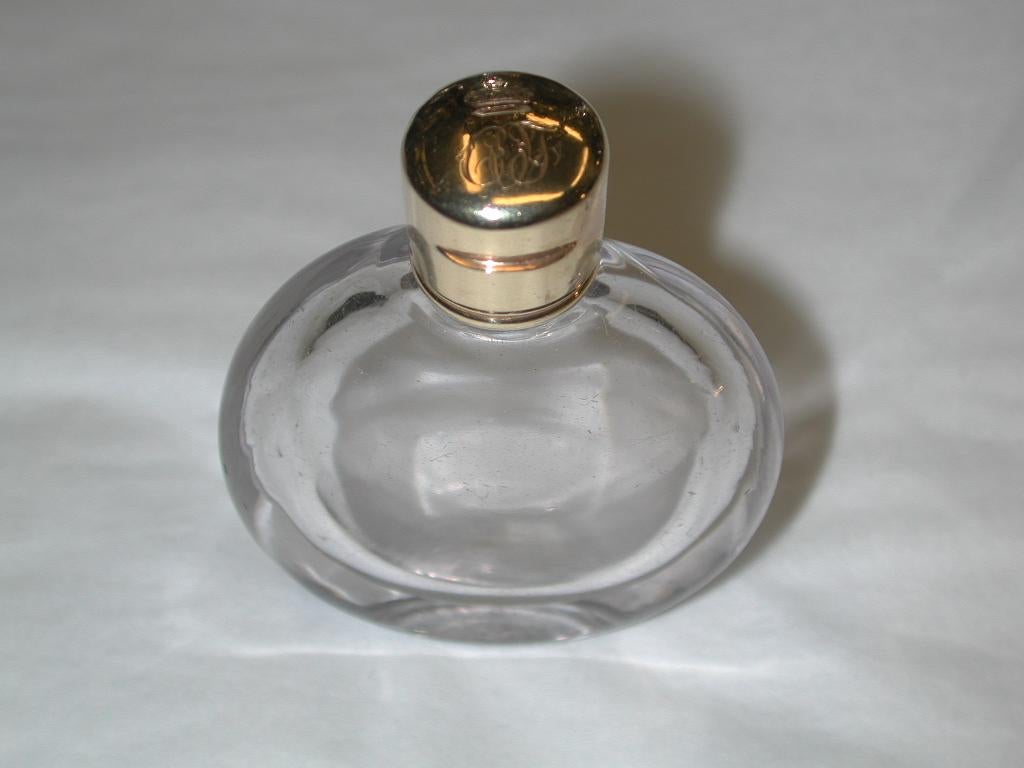 Victorian 18-carat topped glass scent bottle, dated circa 1880.
Heavy quality glass scent bottle with hinged gold lid which has a ducal crest and
 original owners initials.