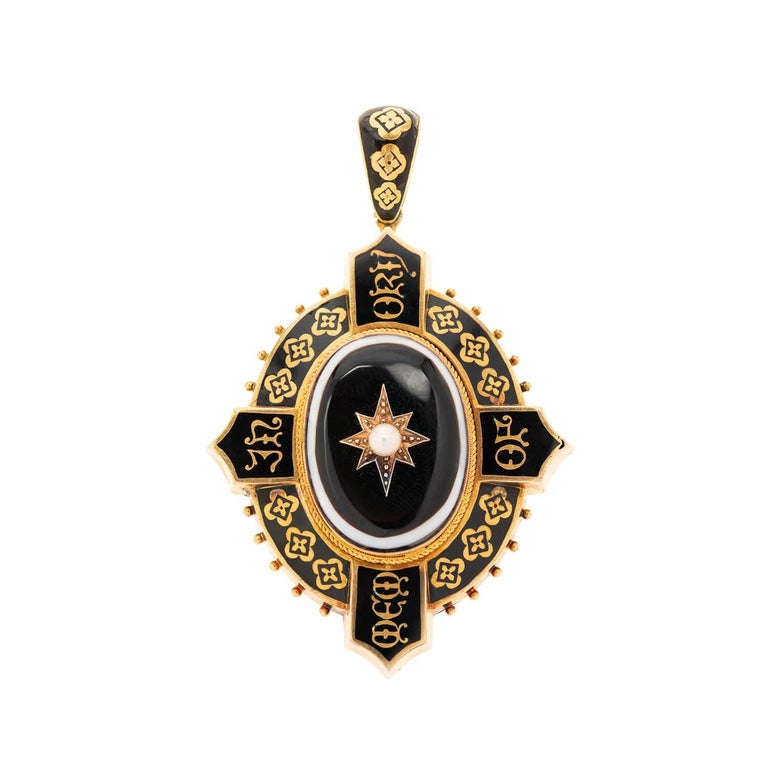 This rare mourning locket from the Victorian (ca1875) era is quite a stunning piece! Crafted in vibrant 18k gold, the decorative locket serves as an incredible example of the mourning jewelry tradition. A delicate white pearl is pin-set in a gold