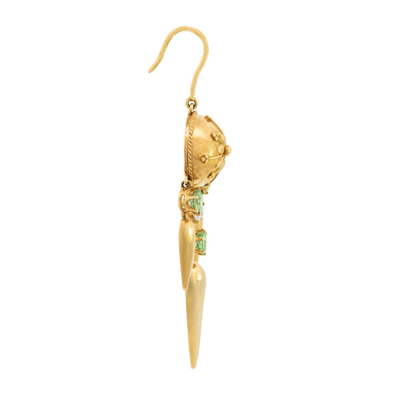 Beautiful diamond and demantoid earrings from the Victorian (ca1880) era! Each of these exquisite Etruscan-style earrings is crafted in 18k vibrant yellow gold. The earring begins with a dome-shaped link, which features a central flower motif. The